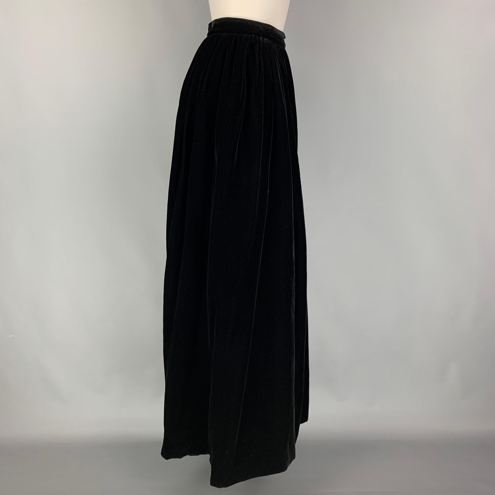 YVES SAINT LAURENT skirt comes in a black rayon featuring a pleated style and a zip up closure. Made in France. 

Very Good Pre-Owned Condition.
Marked: 44

Measurements:

Waist: 28 in.
Hip: 34 in.
Length: 44 in.