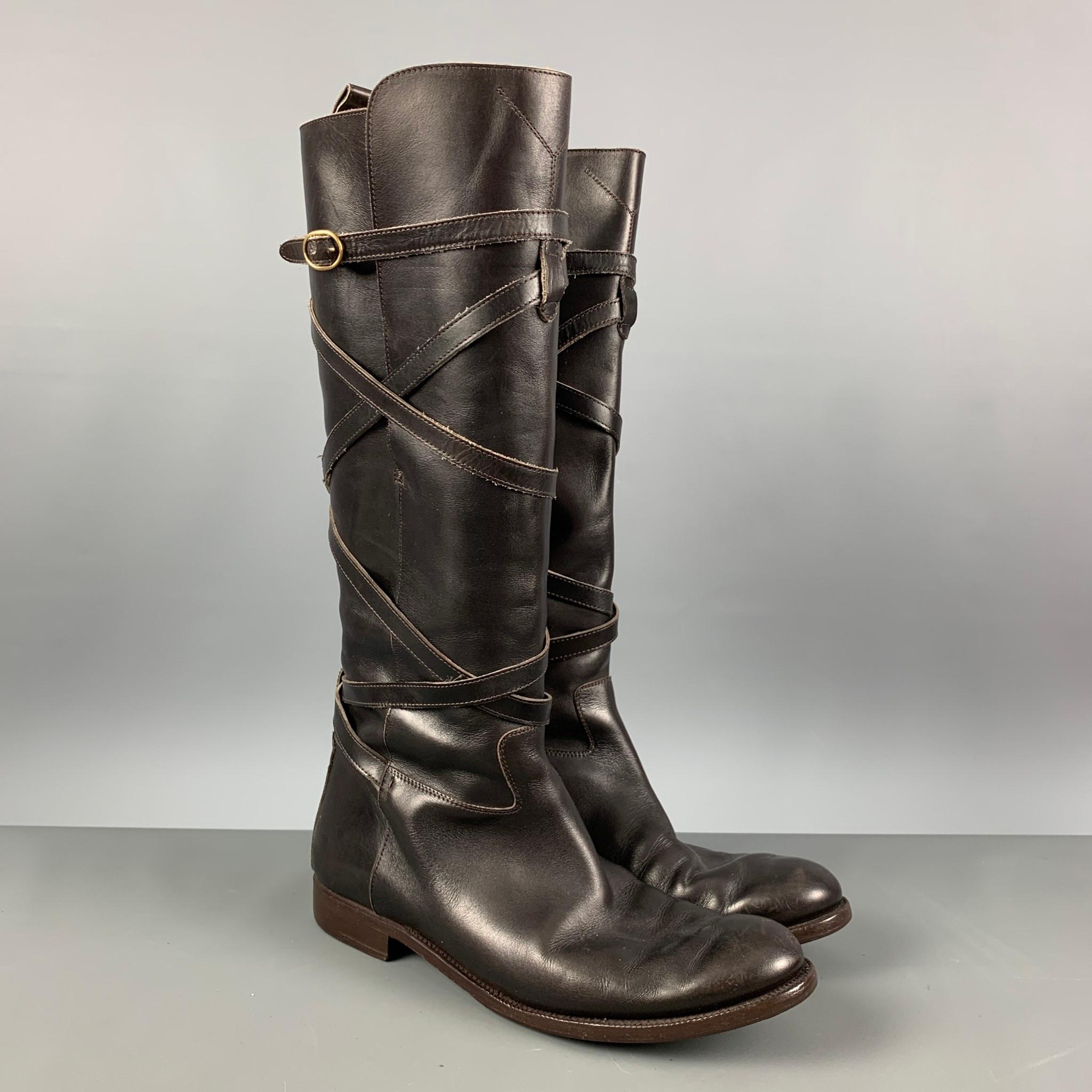 YVES SAINT LAURENT boots comes in a brown leather featuring a round toe, knee high, and a wrap around leather strap style. Made in Italy.

Very Good Pre-Owned Condition. Minor wear.
Marked: 182527 41

Measurements:

Length: 12 in.
Width: 3.75