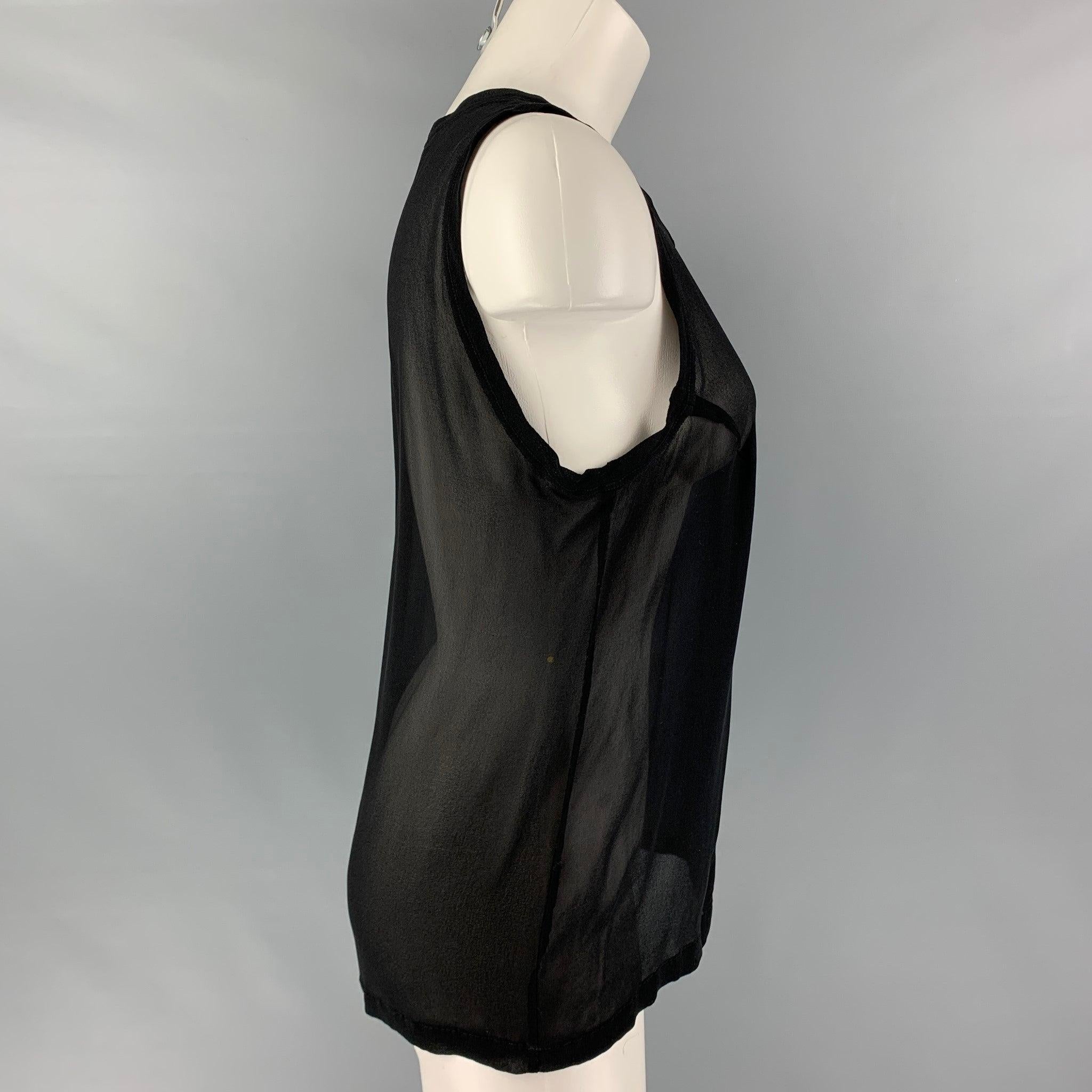 YVES SAINT LAURENT tank top black silk fabric featuring a see through style at back. Made in Italy.Excellent Pre-Owned Condition. 
 

 Marked:  L 
 

 Measurements: 
  Bust: 38 inches Length: 24.5 inches 
  
  
  
 Sui Generis Reference: 121348
