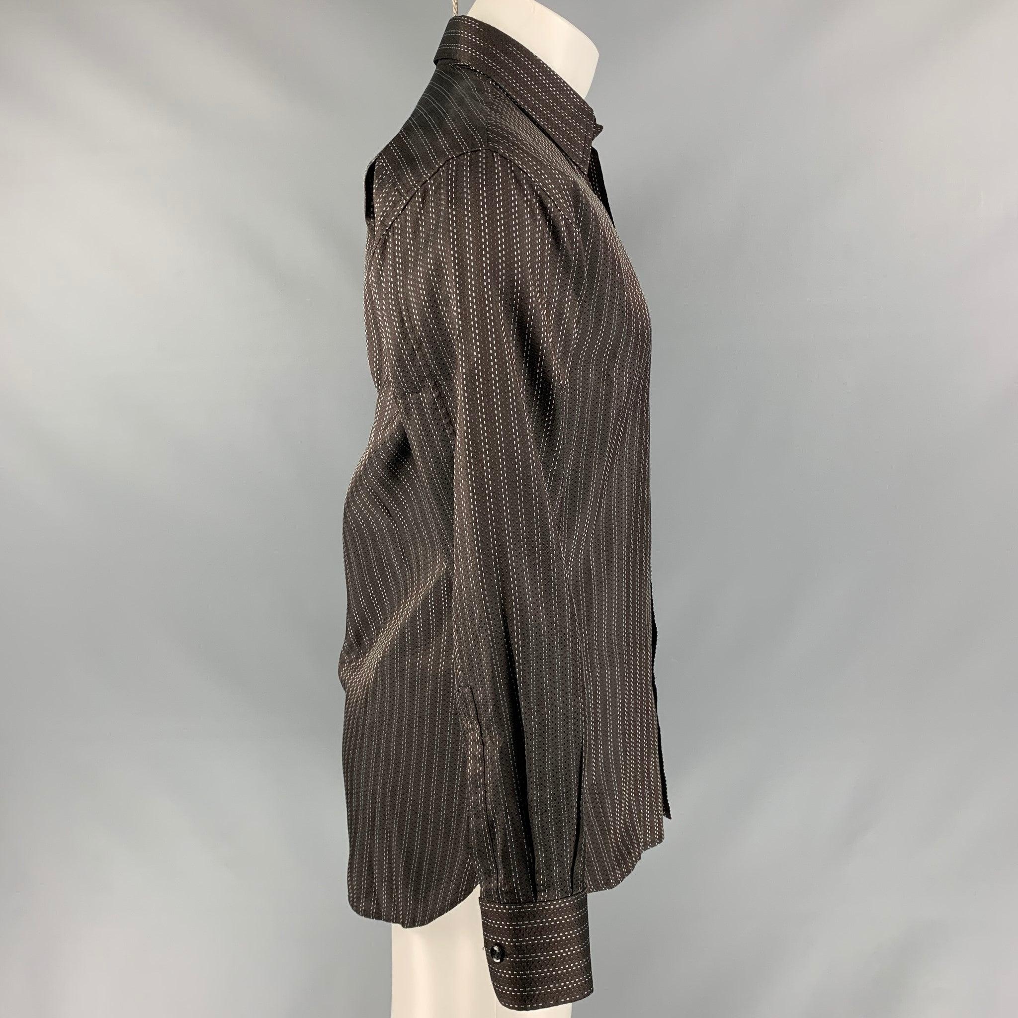 YVES SAINT LAURENT 'Rive Gauche' long sleeve shirt comes in brown and white contrast top stitch fabric featuring a straight collar, a buttoned closure and one button angle cuff. Excellent Pre-Owned Condition. 

Marked:   15.5/ 40 

Measurements: 
