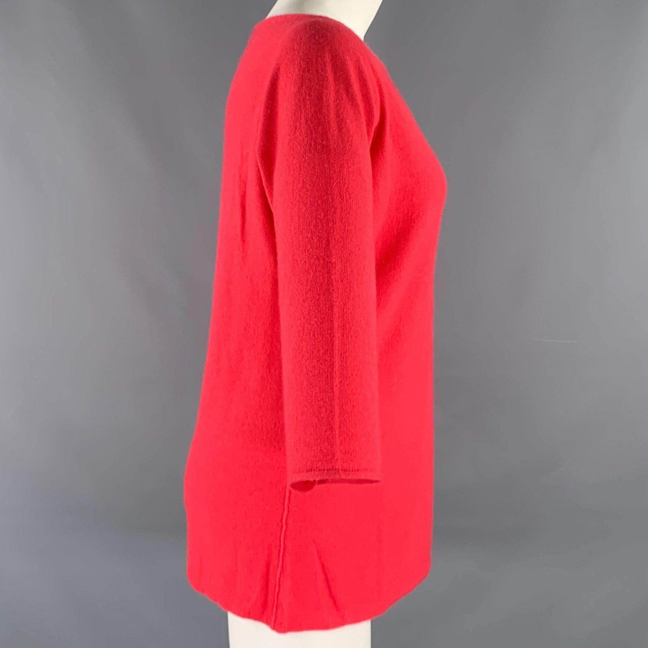 YVES SAINT LAURENT pullover
in a coral pink knit fabric featuring a boat neck and casual dolman sleeves. Excellent Pre-Owned Condition. Fabric and care tags removed. 

Marked:   40 

Measurements: 
 
Shoulder: 17.5 inches Bust: 40 inches Sleeve: 16