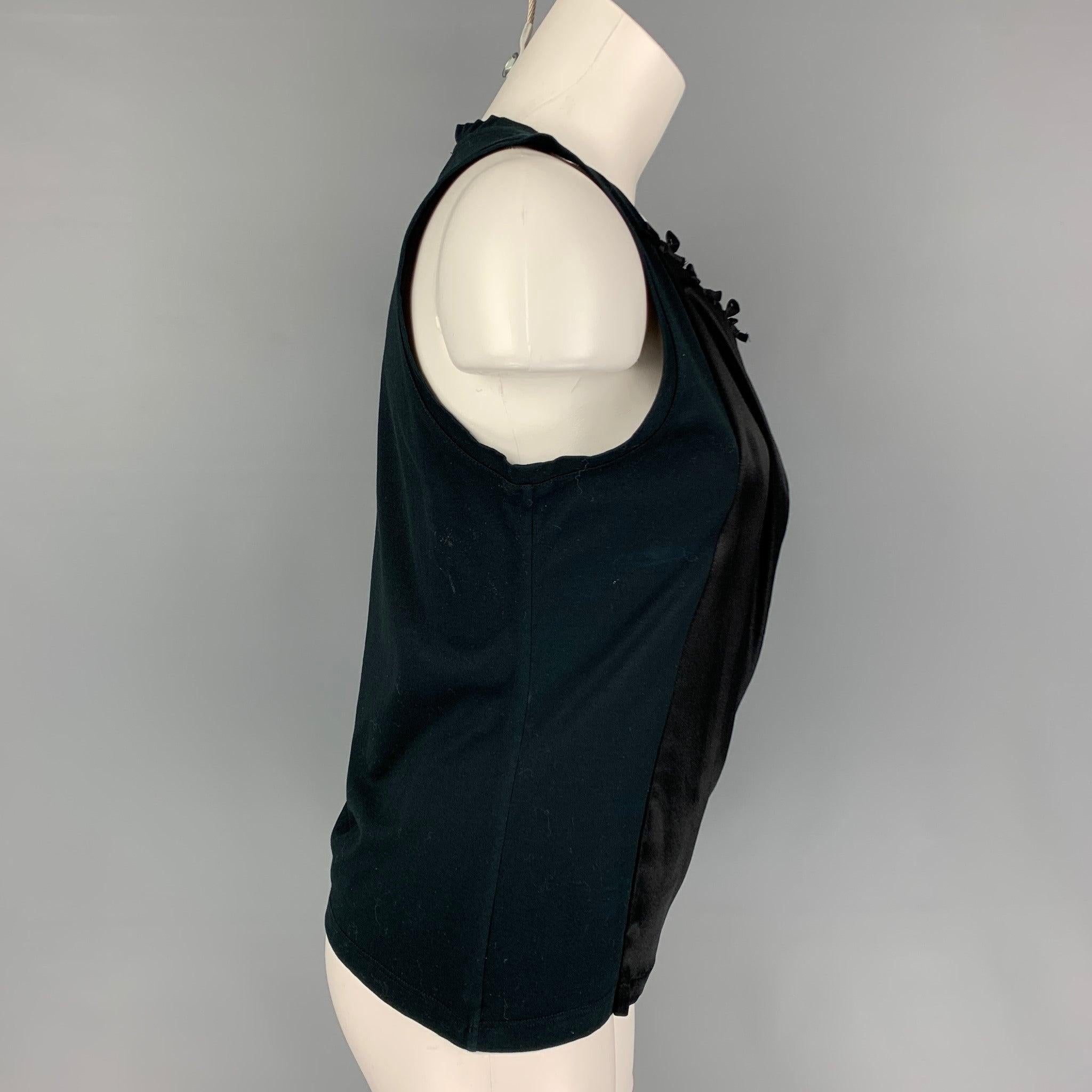 YVES SAINT LAURENT top comes in a black cotton featuring a front silk panel and small bow details. Made in Italy.
Very Good
Pre-Owned Condition. 

Marked:   S 

Measurements: 
 
Shoulder: 11.5 inches  Bust: 32 inches  Length: 21 inches 
  
  
