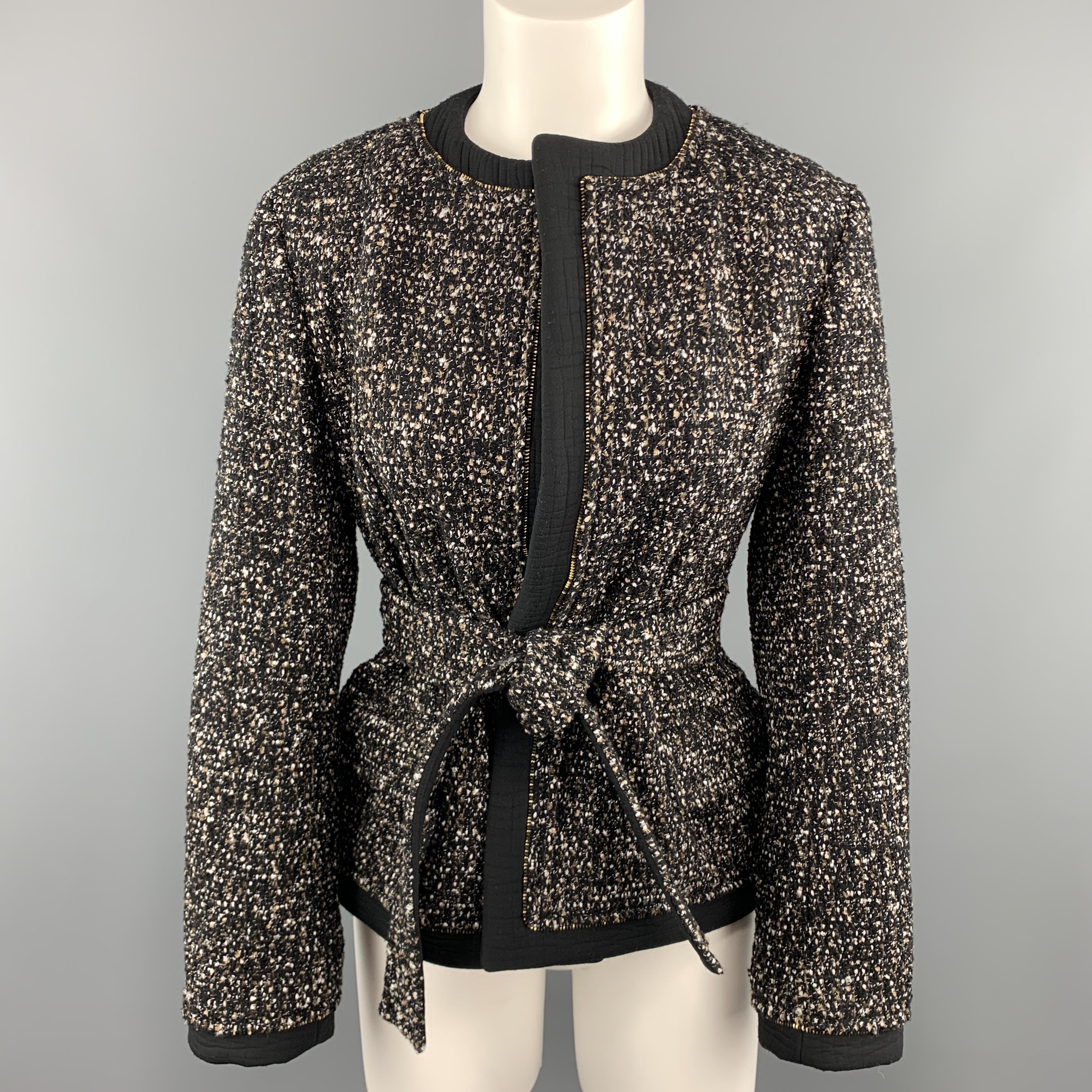 YVES SAINT LAURENT jacket comes in a tan and black wool blend tweed with a cropped hourglass silhouette, round, collarless neckline, flap pockets, black crocodile fabric textured trim, tie waistband, and zipper piping. Made in France.

Excellent