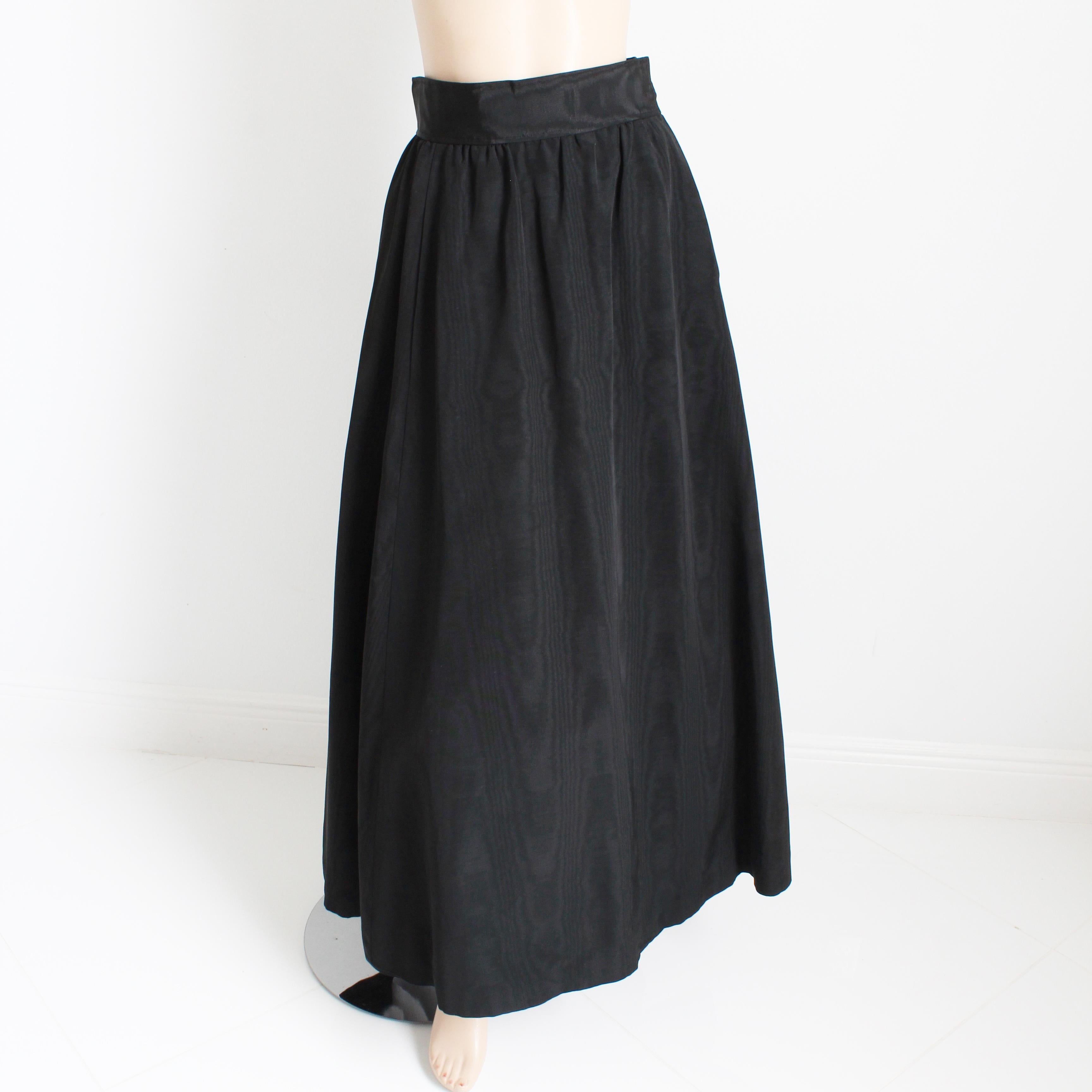 Authentic, preowned, vintage Yves Saint Laurent Rive Gauche black moire maxi skirt, likely made for the Ballet Russes or Russian collection in the late 70s. Made from a moire taffeta fabric (no content label), it fastens with hook/eye closures and a