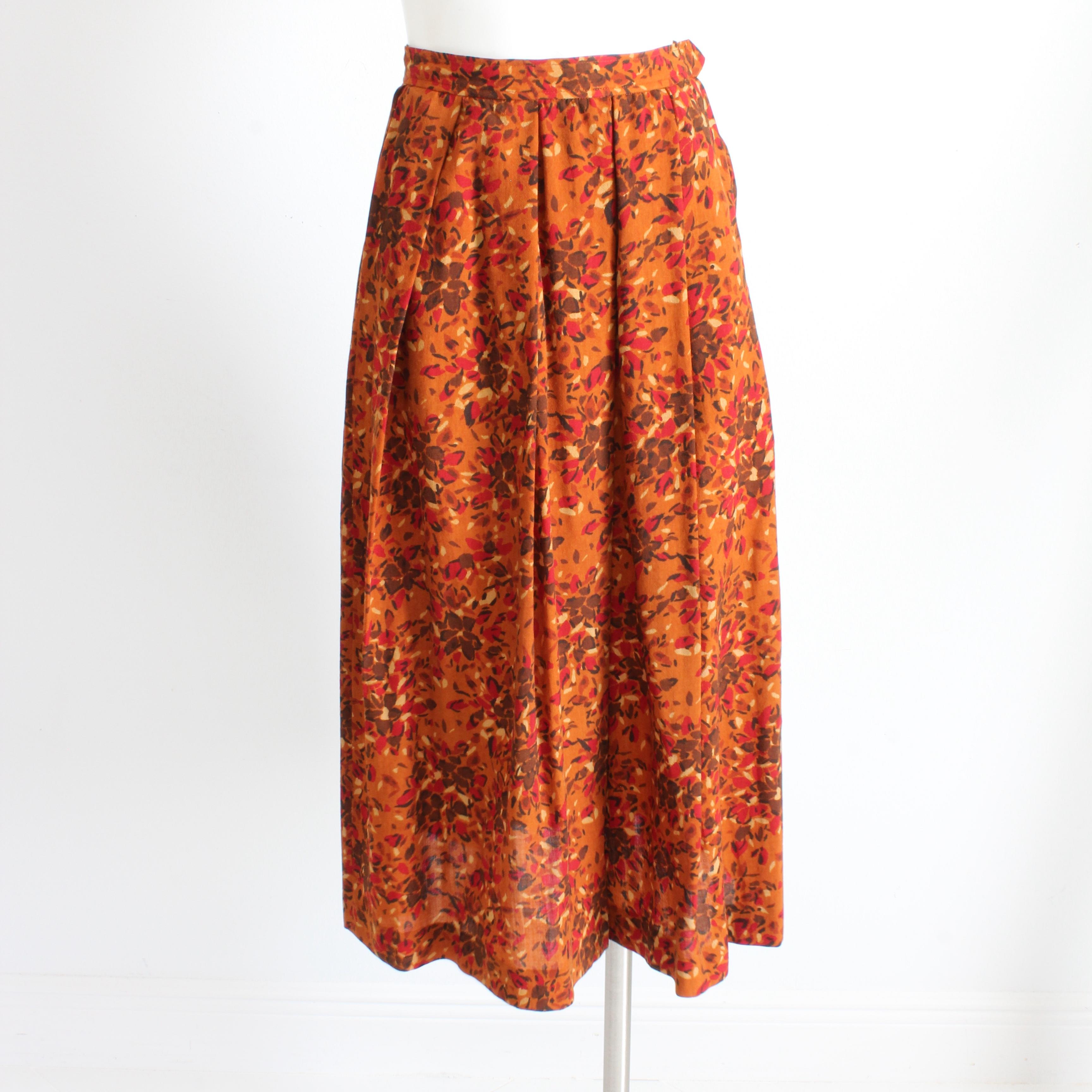 Authentic, preowned, vintage skirt by Yves Saint Laurent Rive Gauche, most likely made in the early 1980s.  Made from what we believe is a lightweight wool or wool blend fabric (no content label), it features an abstract graphic floral print in