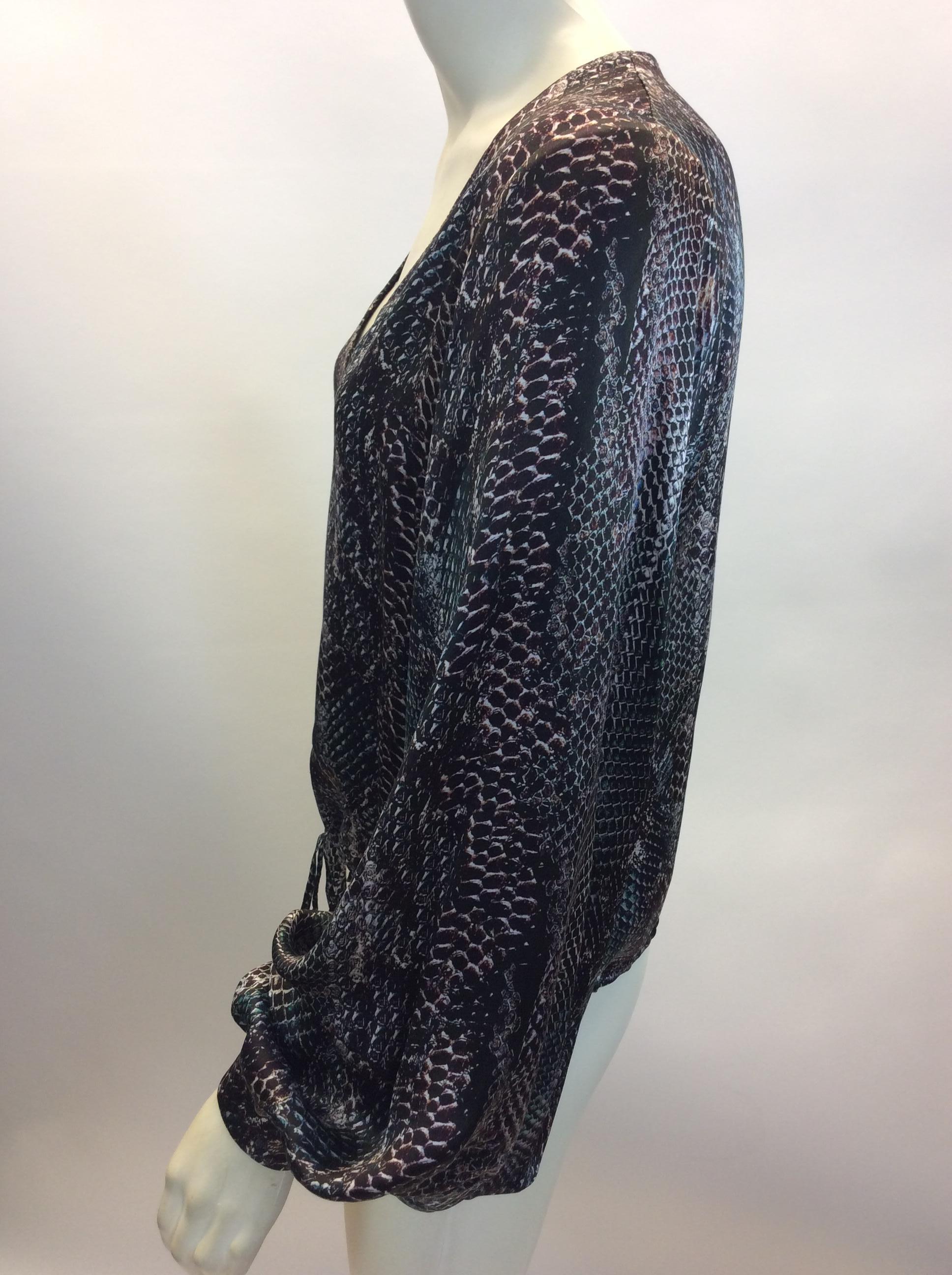 Yves Saint Laurent Snake Skin Print Silk Blouse
$165
Made in Italy
100% Silk
Size 36
Length 20.5