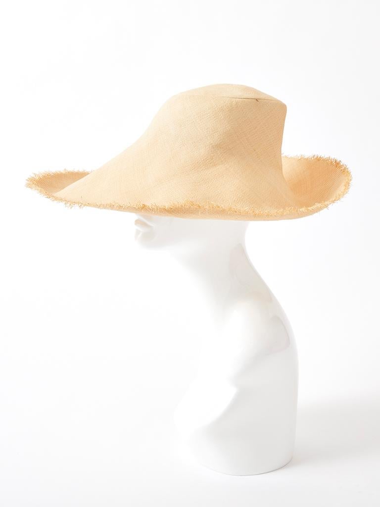 Yves Saint Laurent, natural tone, wide brim straw hat with frayed edges.