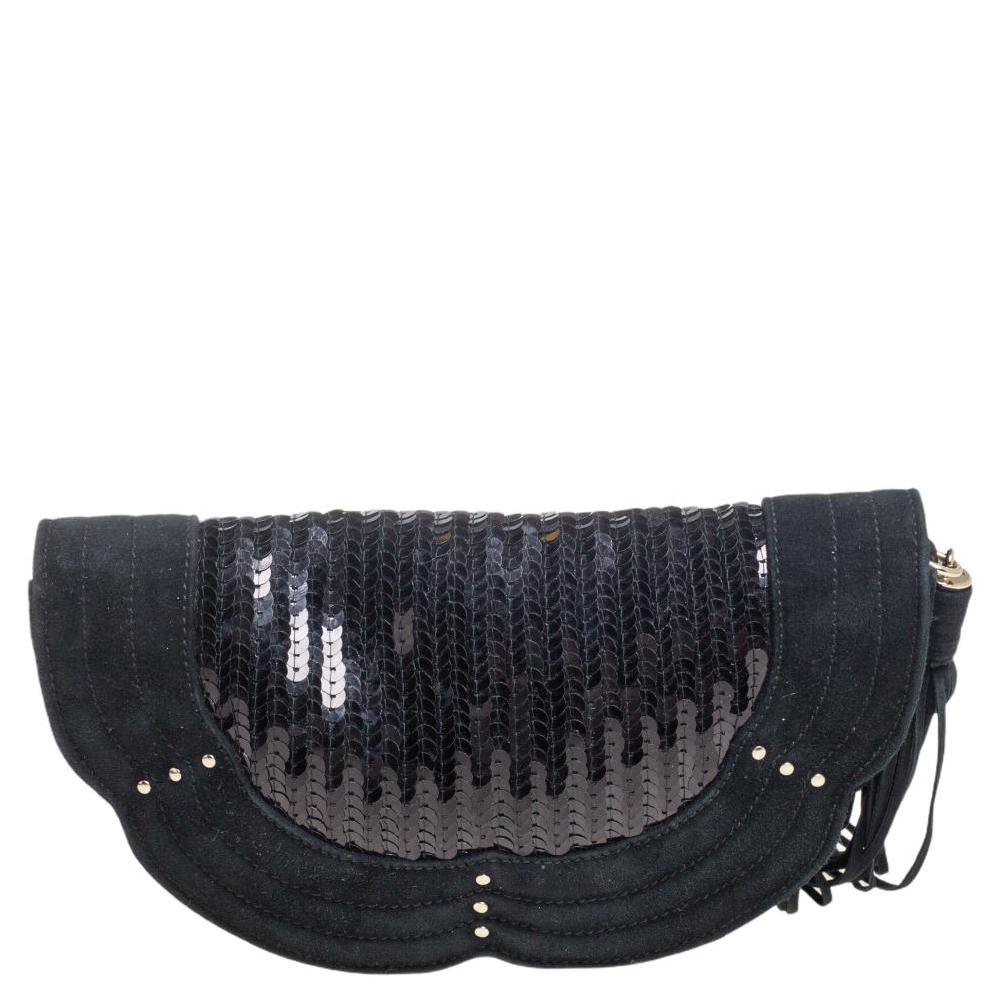 This Yves Saint Laurent clutch is just the right accessory to compliment your ensemble. It comes crafted in black suede and decorated with sequins all over. It has a satin-suede interior that can comfortably hold your essentials.

Includes: Original