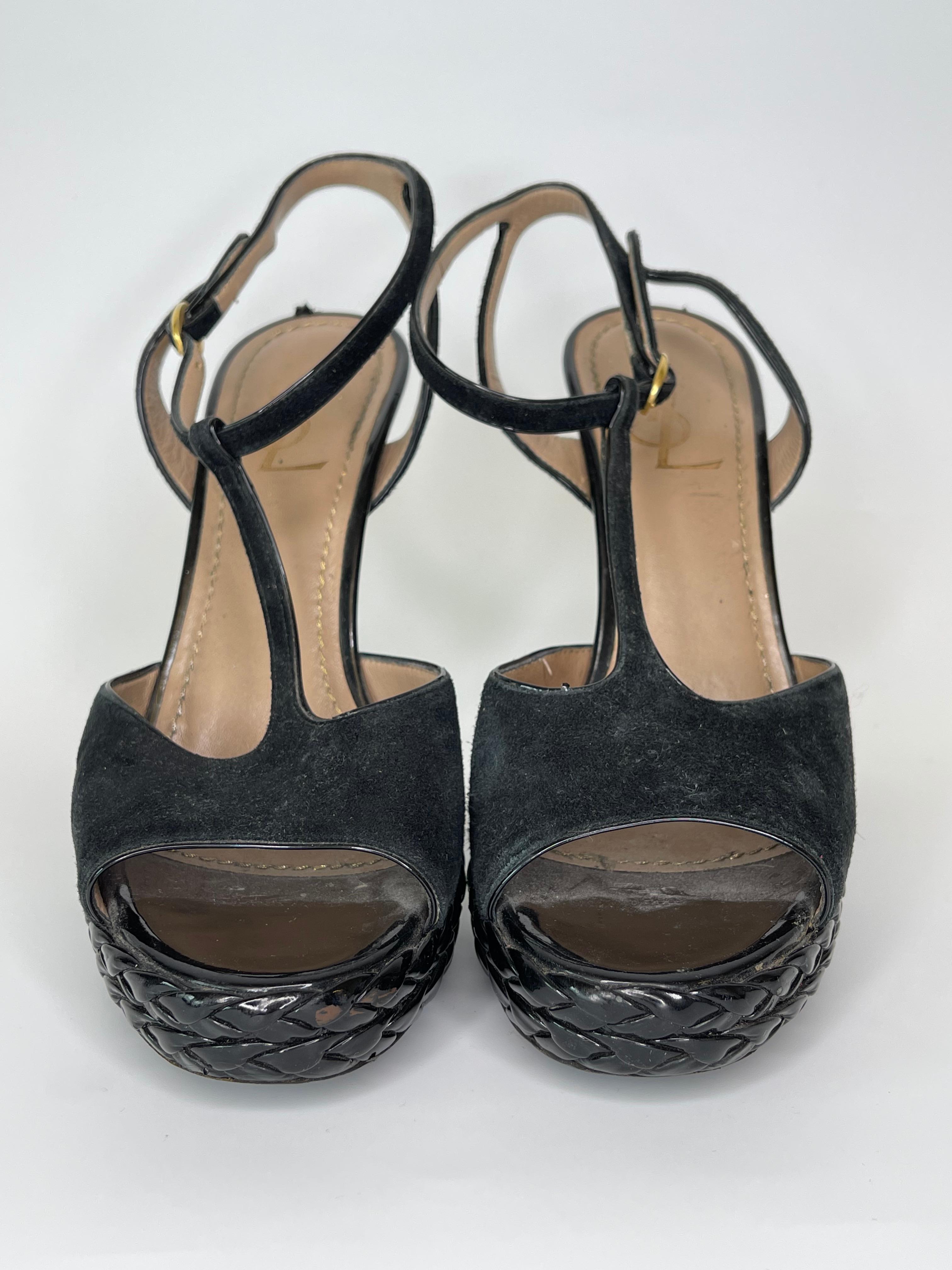 These YSL t-strap suede open toe stilettos are a beautiful black colour, with a basketweave design near the toe. Gold stitching throughout the interior. Buckle at the heel to hold in place.

COLOR: Black 
MATERIAL: Suede, leather insole with leather