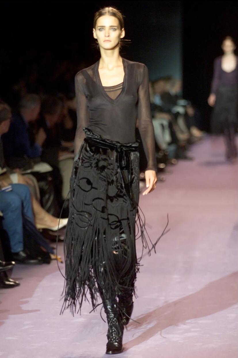 - Yves Saint Laurent
- Tom Ford Era
- From the A/W 2001 Runway Collection
- Velvet with thick woven Fringing
- High Waisted Flexible Fit With Self Tie Belt
- Size French 40 
- Sold by Mae Vintage London

