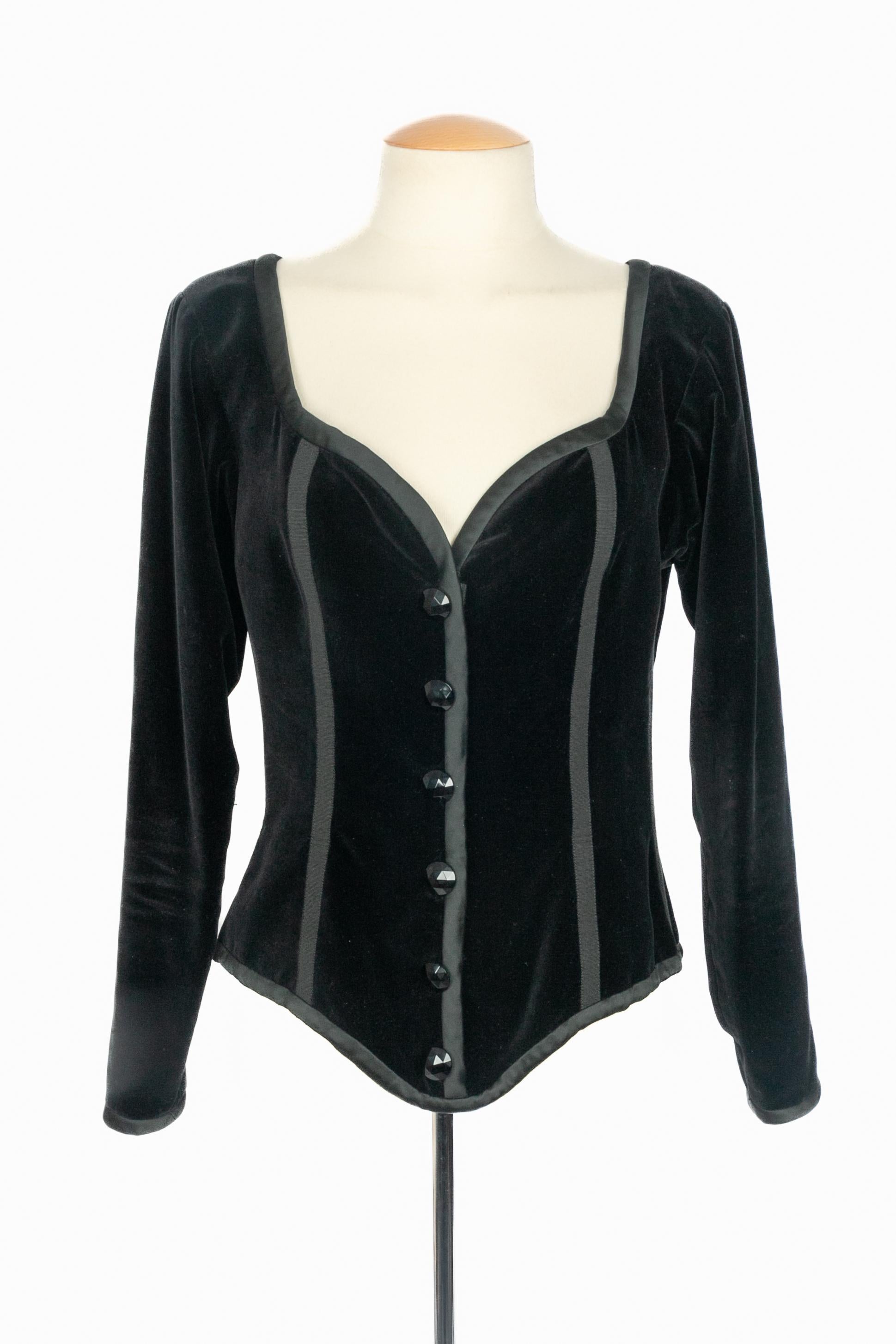 YVES SAINT LAURENT - (Made in France) Black velvet long-sleeve top edged with black satin. Black faceted buttons and zipper on the front. Size 38FR indicated. A Collection circa 1990 under the artistic direction of Yves Saint