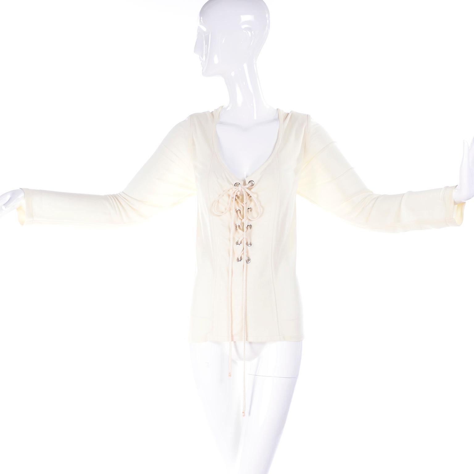 This is a lovely 1990's vintage cream silk or silk blend  jersey top from Yves Saint Laurent in a Victorian style with its corset style lace ties and rivets in the front.  The top is a size 42 and measures like a modern day size 10/12.  Please use