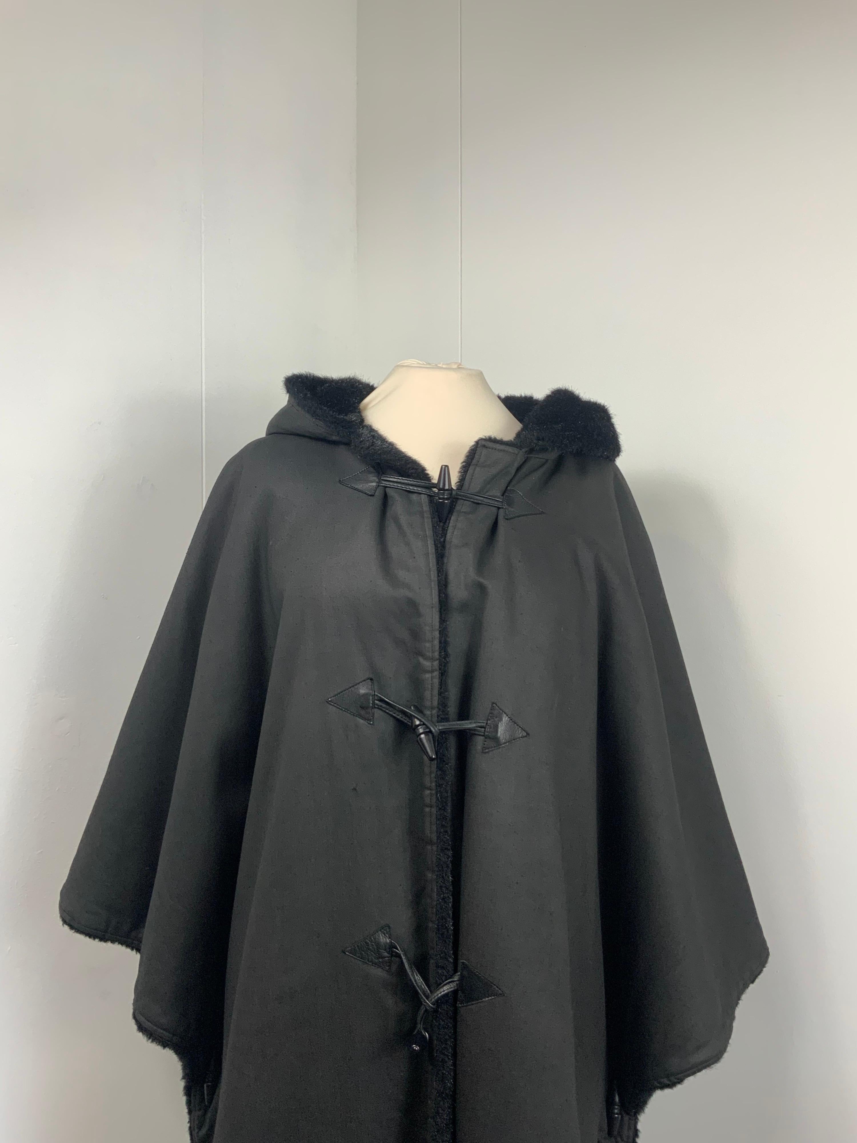 Yves Saint Laurent Cloak.
The composition label is missing.
Interior in black ecologic fur.
Leather details.
Size 38 FR. It fits a 42 Italian.
Shoulders 43 cm
Bust 50 cm circa 
Length 105 cm 
Conditions: Good - Previously owned and gently worn, with