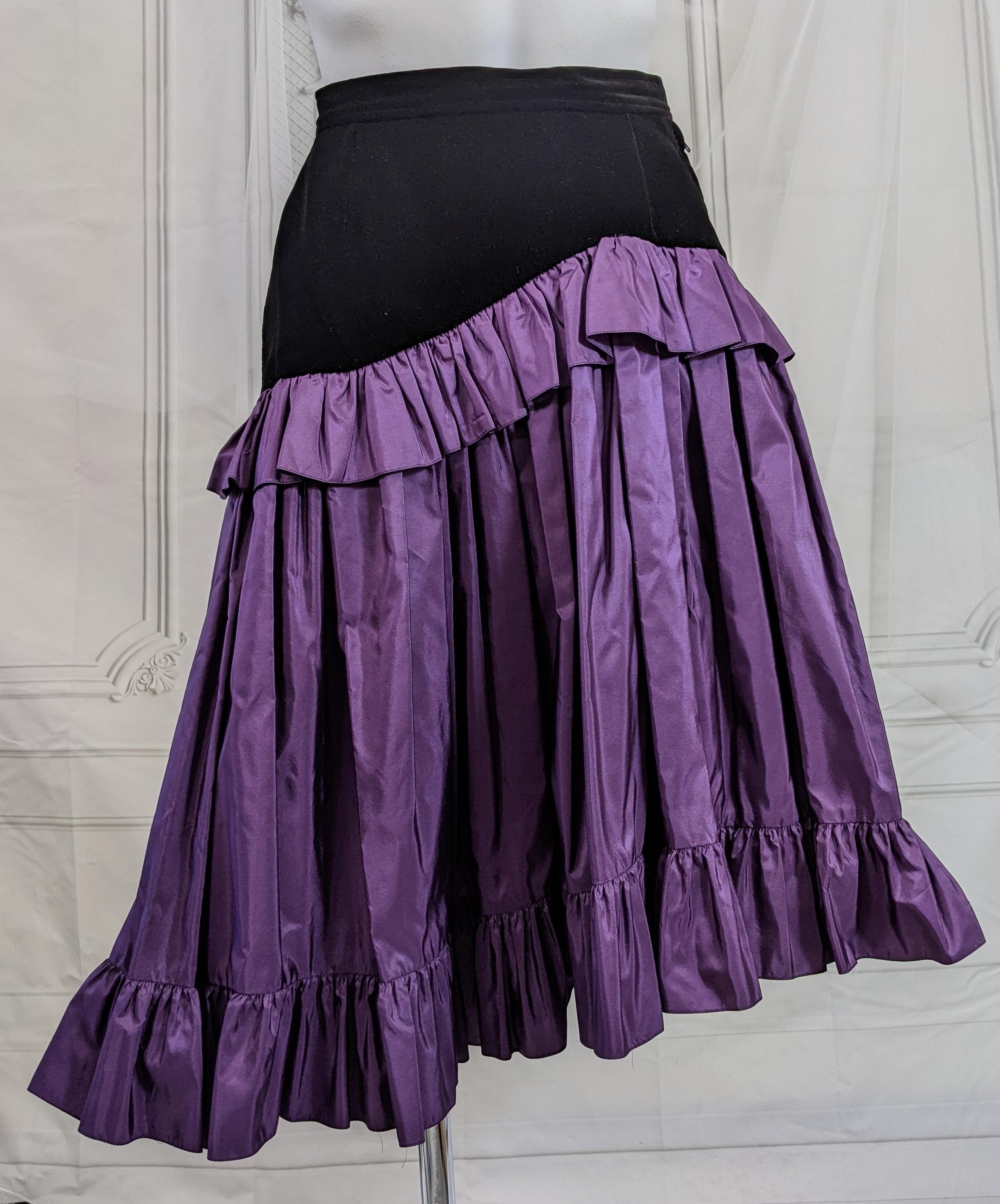 Yves Saint Laurent Velvet and Taffeta Skirt, Russian Collection. Black velvet mixed with iridiscent purple silk taffeta which is hiked up slightly at left hip and trimmed with ruffles through out.
1970's France, Vintage size 34. France.
Length 25