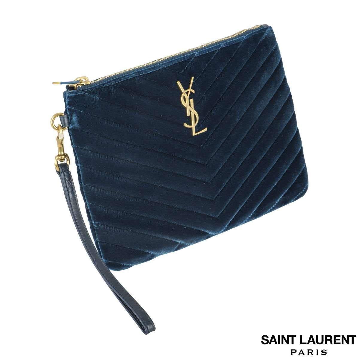 This unworn YSL clutch in midnight blue velvet stitched in a chevron pattern contrasts beautifully with the gold logo in front. The fabric lined interior comes with flap pocket. The bag is unworn in condition and comes along with its box, Dustbag