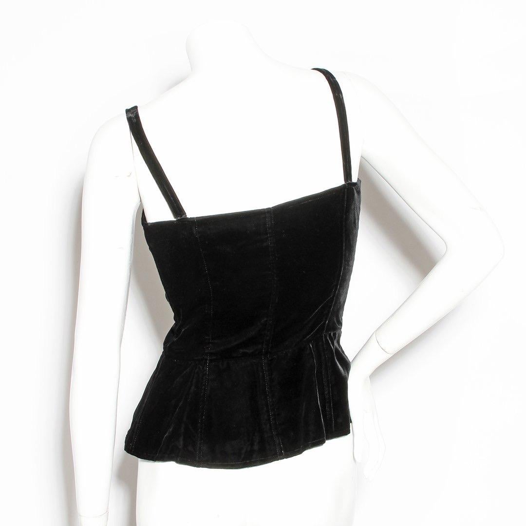 Velvet corset tank by Yves Saint Laurent Rive Gauche
Circa 1970s
Black velvet
Rope lace-up front closure
Tassel detail on rope 
Peplum bottom 
Sweetheart neckline 
Made in France
Condition: Excellent vintage condition, little visible wear. Small