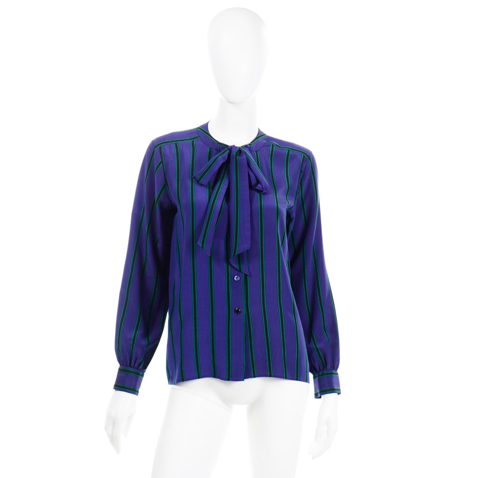 This beautiful Yves Saint Laurent Rive Gauche vintage blouse is in a luxe purple, black and green striped silk. We love the sash attached to the rounded collar that can be tied in a simple knot or a bow. This blouse is a timeless piece that is from