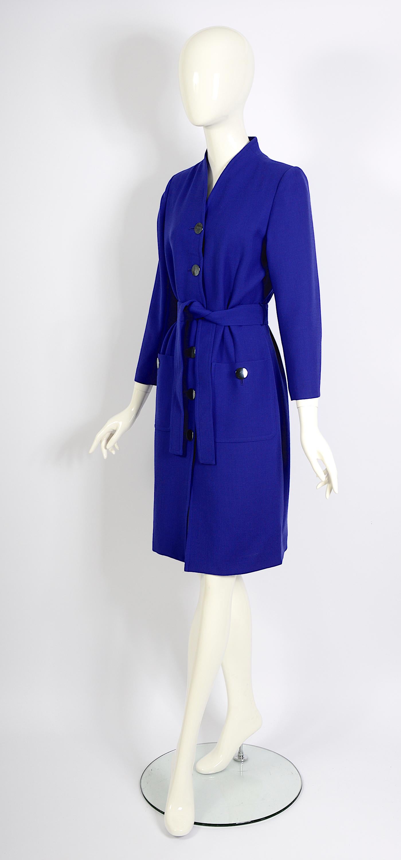 A stunning Yves Saint Laurent variation vintage cobalt blue wool jacket from the 1980s, versatile enough to be worn as a dress. It features a button-front closure and includes a matching tie belt for a flattering fit.
Made in France 
French size