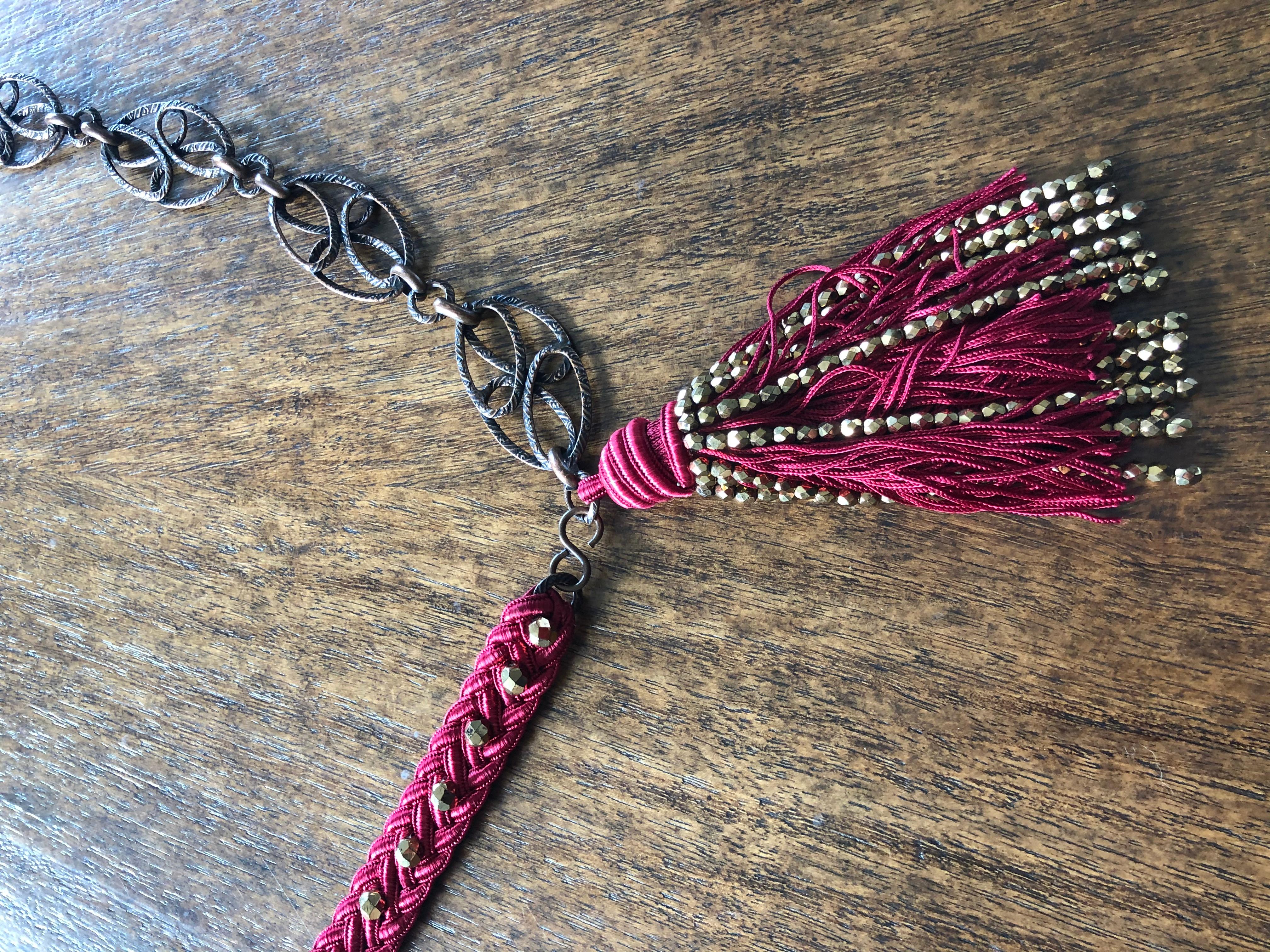 Yves Saint Laurent Vintage 70's Red Cord Beaded Belt with Chain Links and Tassel
This is designed to wear slung low over the hips and will fit up to 32