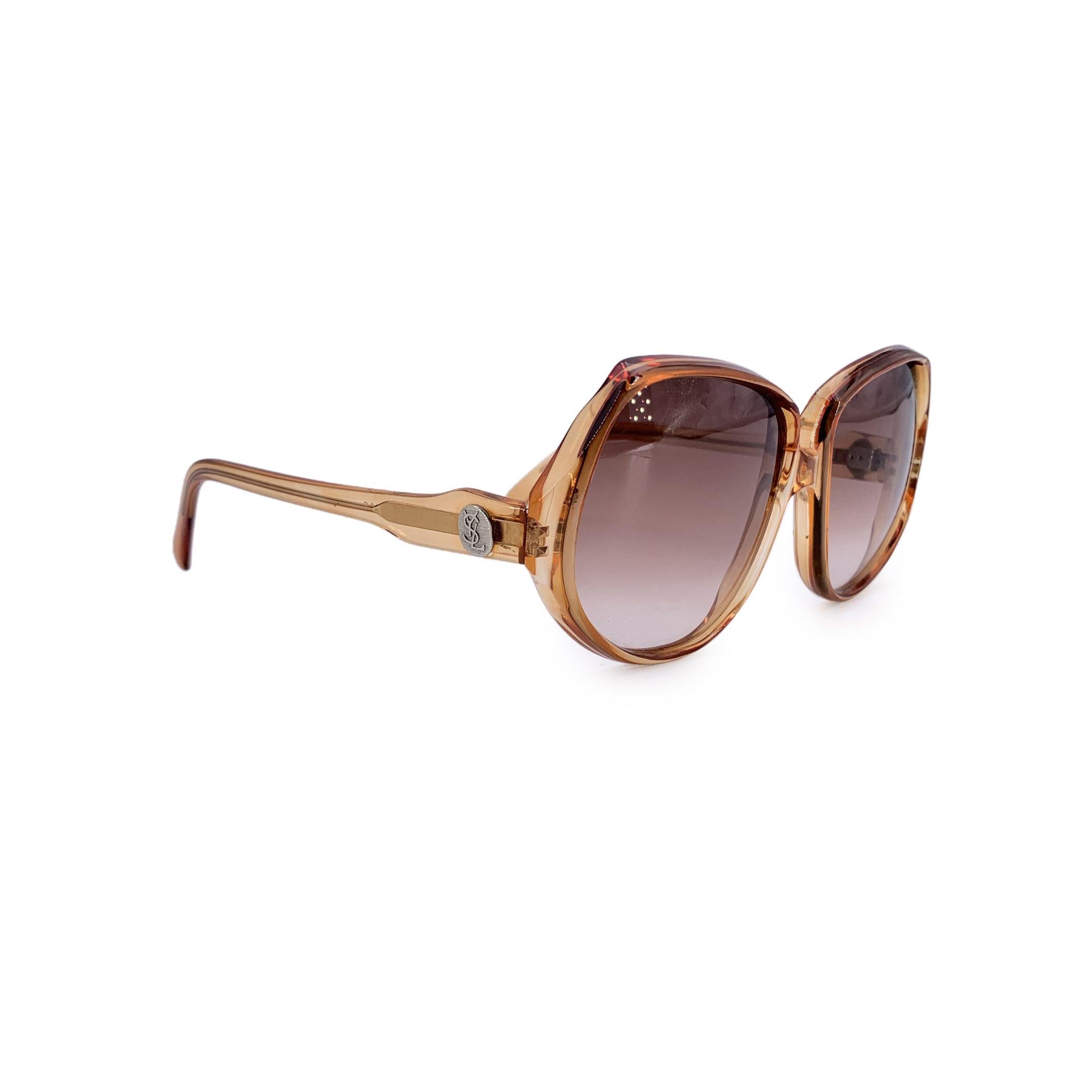 A timeless piece from the golden era of designer eyewear, these vintage Yves Saint Laurent sunglasses, model Delias (52/18), offer understated elegance with a distinctly French touch. Made in France, the frame features a warm, classic light