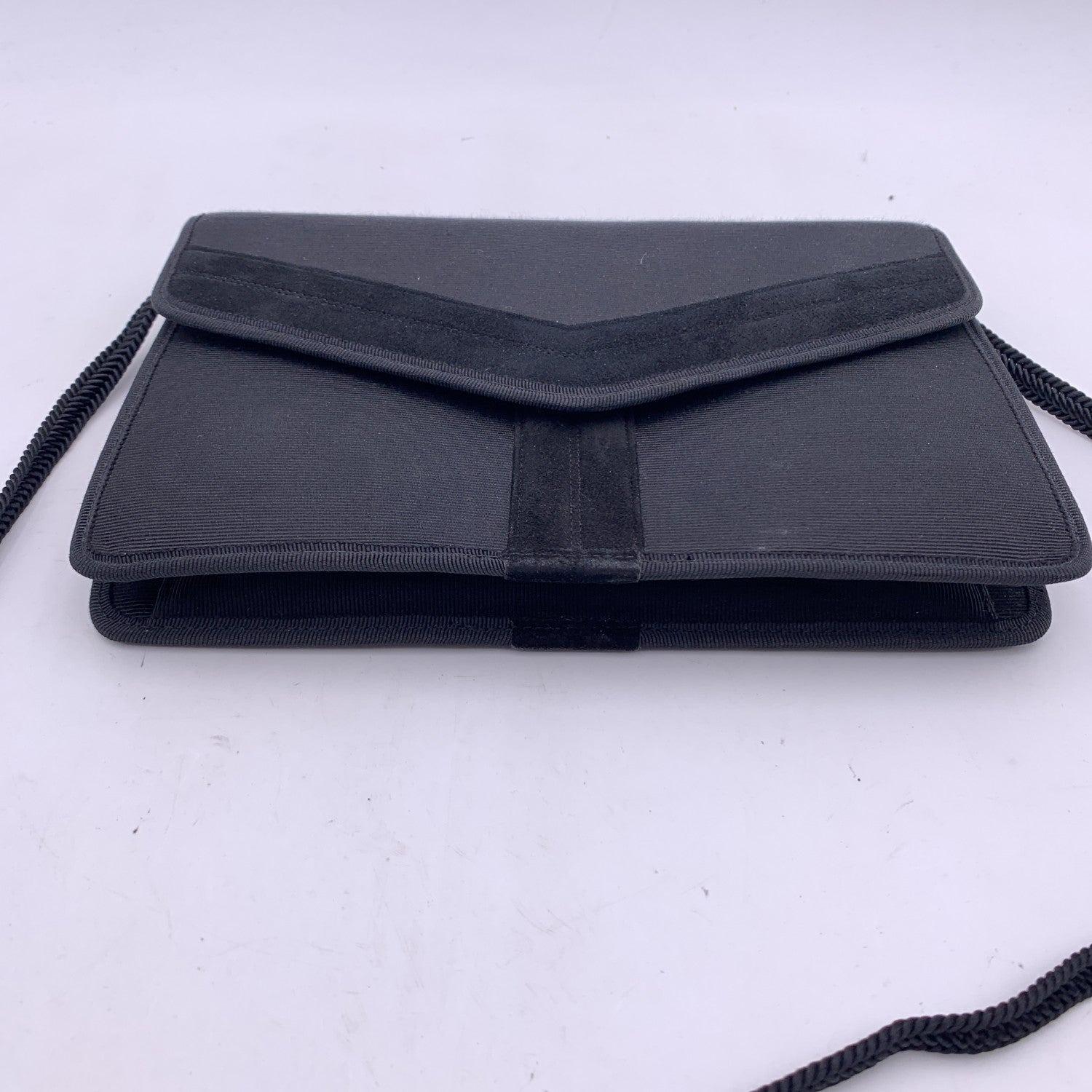 Yves Saint Laurent evening bag in black grosgrain fabric with suede Y on the front. Flap with magnetic button closure. Black fabric lining. 1 side open pocket inside.'Yves Saint Laurent - Made in France' tag inside Condition A - EXCELLENT Gently