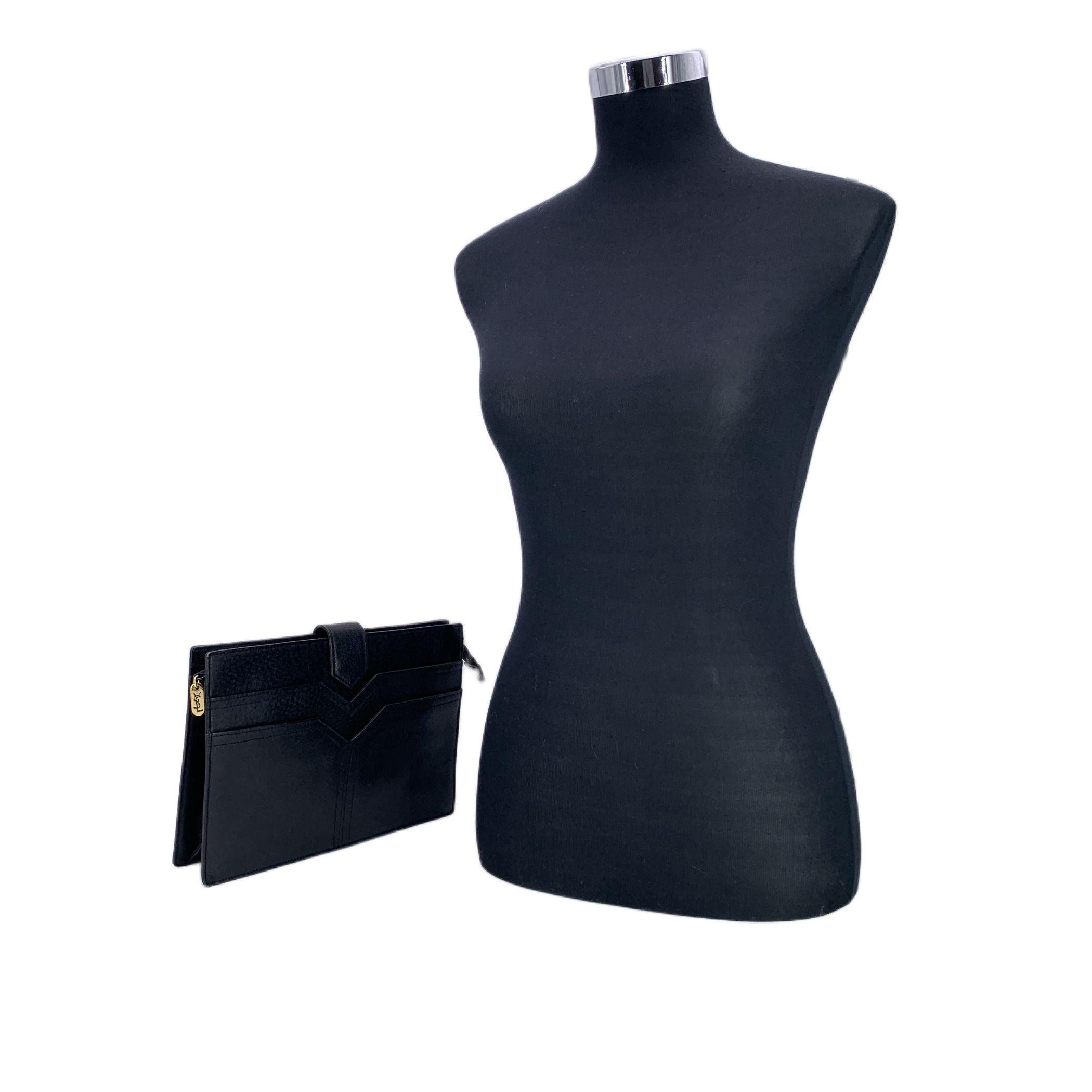 Effortlessly refined with a touch of Parisian edge, this Yves Saint Laurent Vintage Leather Clutch Bag is a quiet statement piece from the golden age of YSL design. Crafted from supple black leather, its sleek silhouette is accented by a fold-over