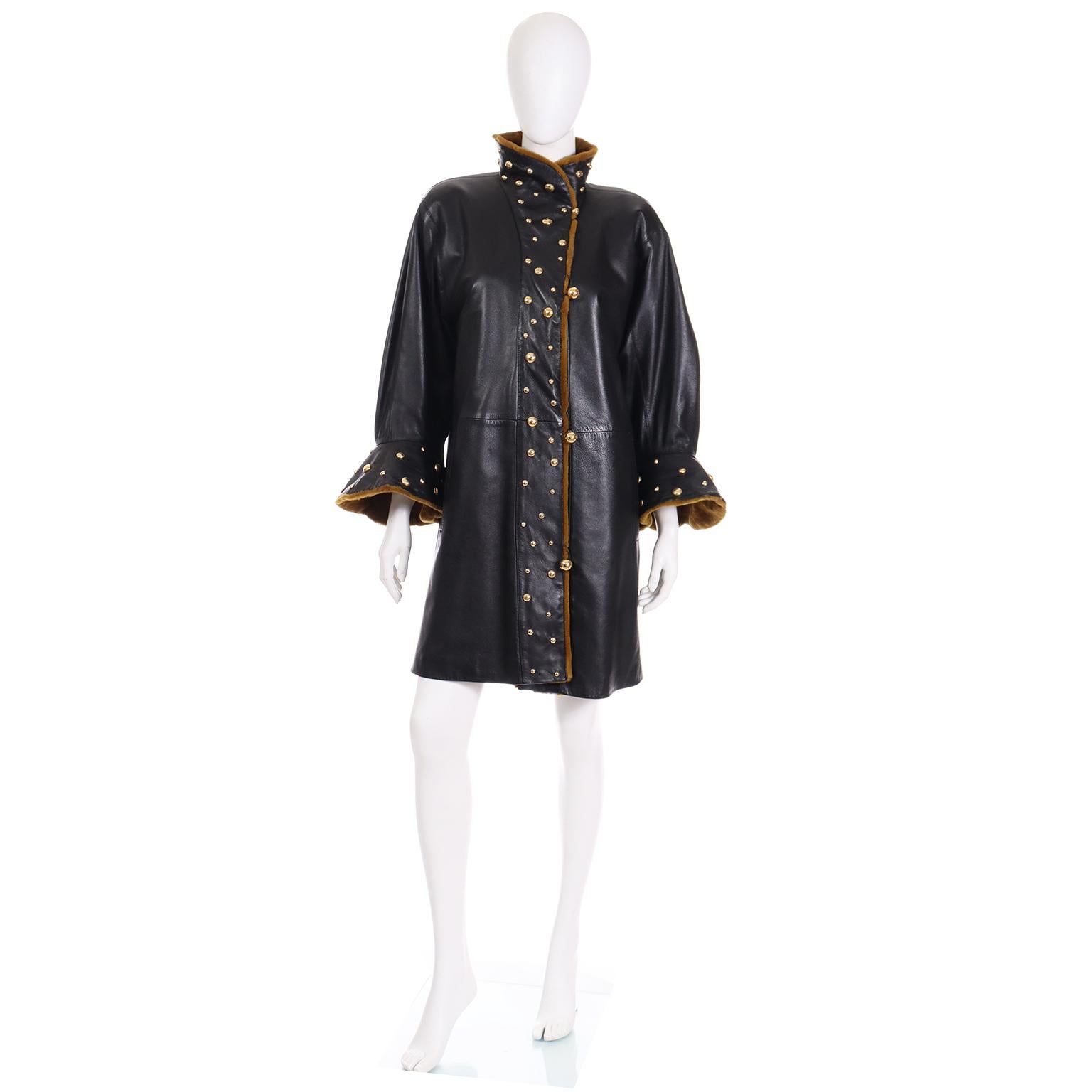 This is a sensational 1980's vintage black leather Yves Saint Laurent Fourrures Coat with sheared mink lining and trim. This rare vintage coat has dramatic gold studs down the front, on the collar and on the flared cuffs.

This stunning YSL coat is