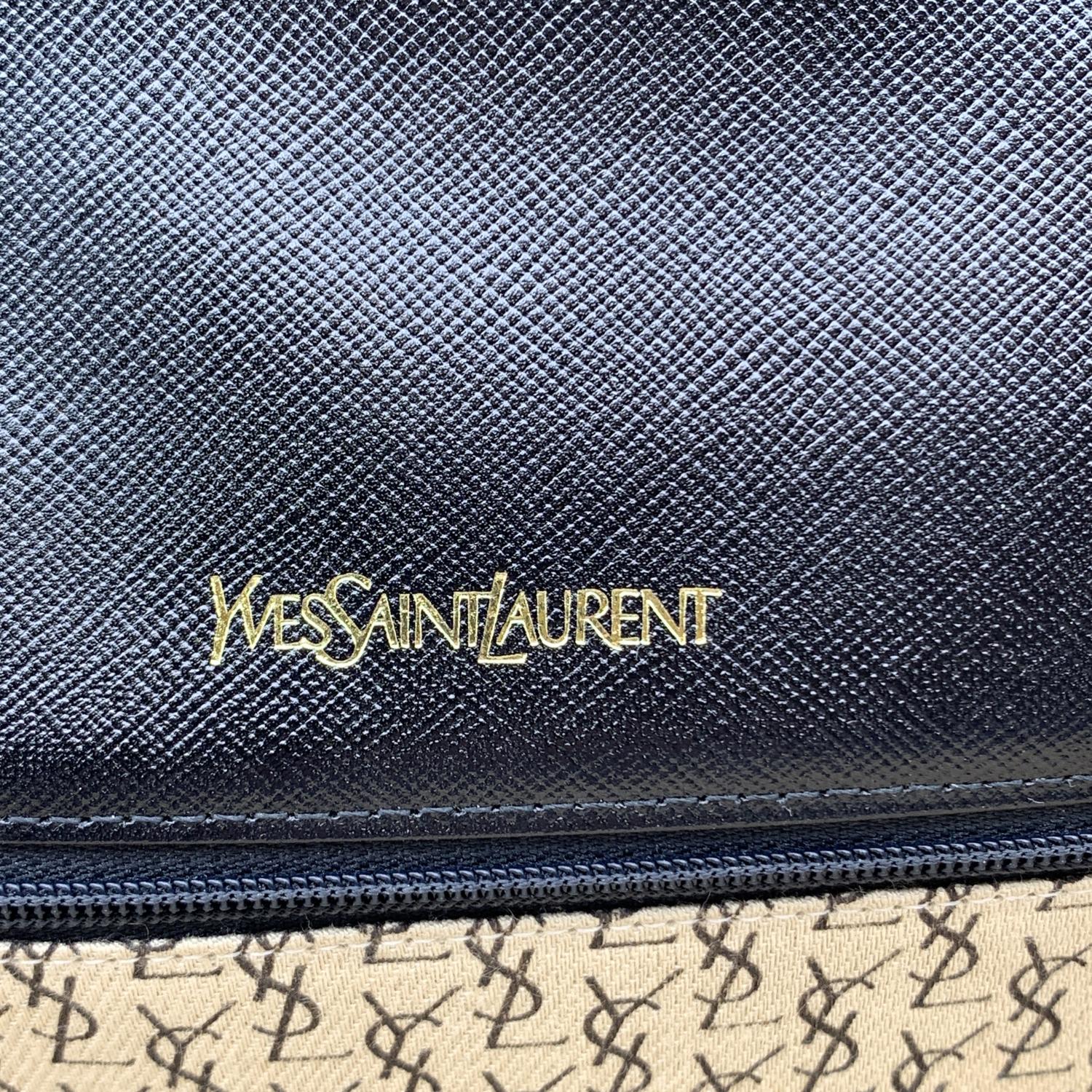 Yves Saint Laurent vintage clutch bag, crafted in black leather. It features a flap with magnetic button closure on the front. YSL logo on the front. 1 rear open pocket. Beige fabric lining. 1 side zip pocket inside. 'YVES SAINT LAURENT'embossed