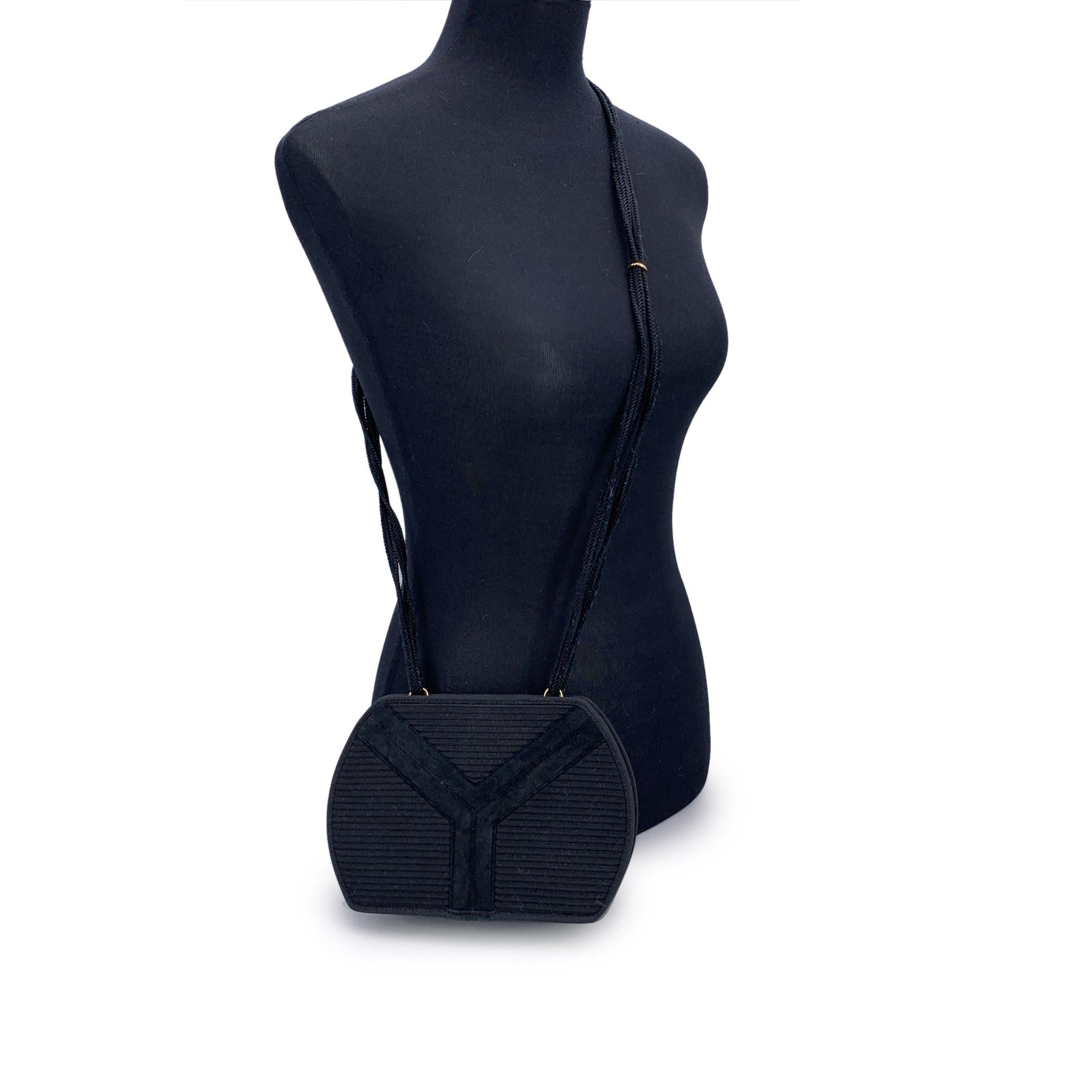 A timeless piece from the golden era of understated elegance, this vintage Yves Saint Laurent messenger bag captures the essence of quiet luxury. Crafted in rich black ribbed fabric, the bag features a bold yet refined suede 