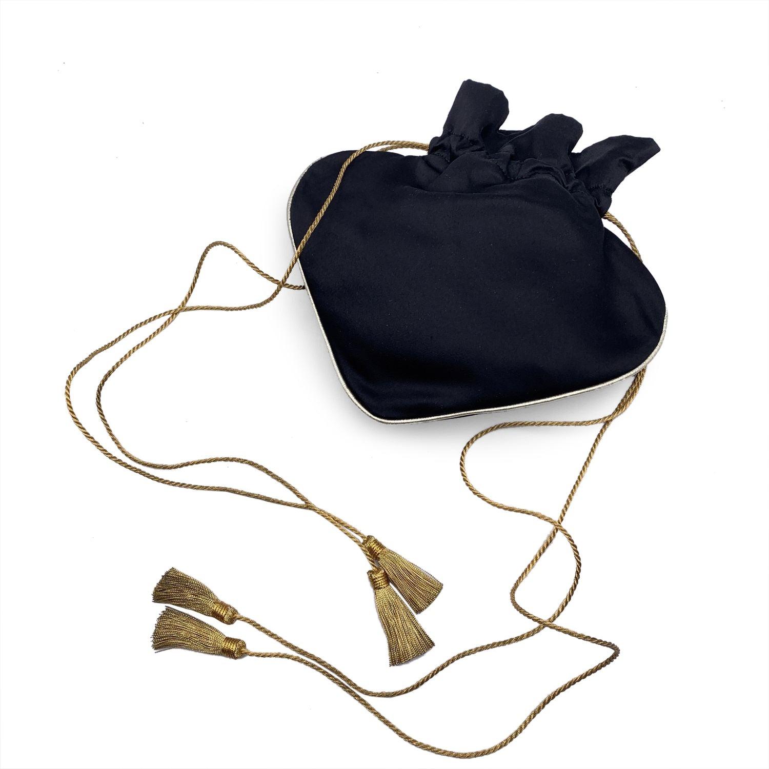 Gorgeous vintage rare small drawstring evening bag by Yves Saint Laurent. In black satin with gold metal trim, the bag features a fancy ace of spades shape. Drawstring closure. Black internal lining. Adjustable shoulder strap. Tassel detailing on