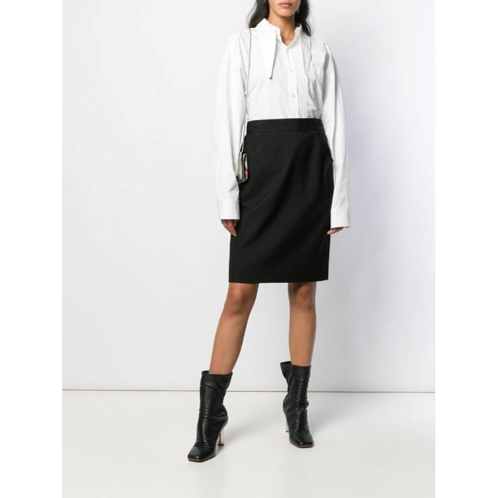 Yves Saint Laurent black wool midi straight 80s skirt with welt pockets and side buttons and zip fastening.

Size: 40 IT

Flat measurements
Height: 60 cm
Waist: 36 cm
Hips: 43 cm

Product code: A8333

Composition: 100% Wool

Made in: