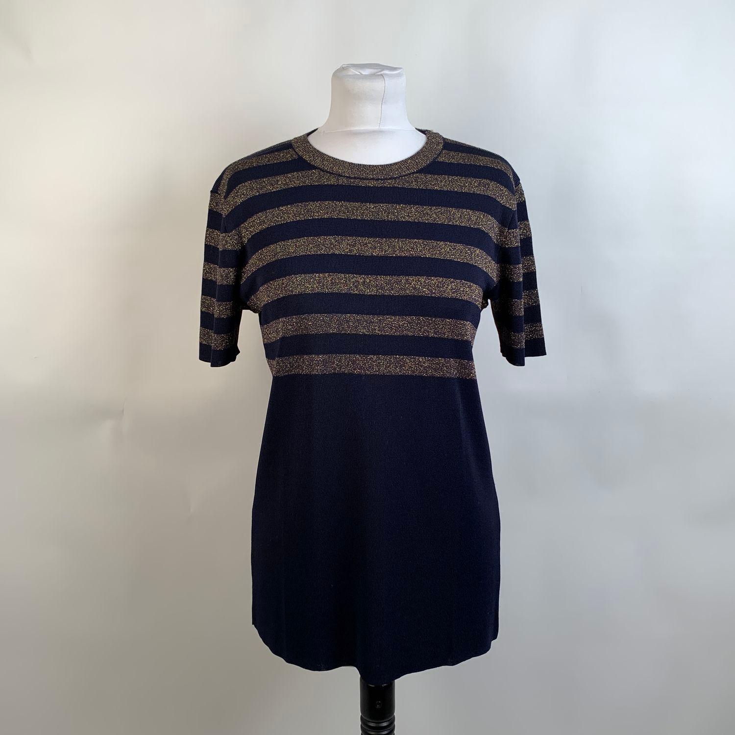 Vintage Yves Saint Laurent navy blue short sleeve jumper. Gold tone stripes detailing on the upper part. Crew neckline. Composition: 84% viscose, 16% polyester. Size: 42 FR (The size shown for this item is the size indicated by the designer on the