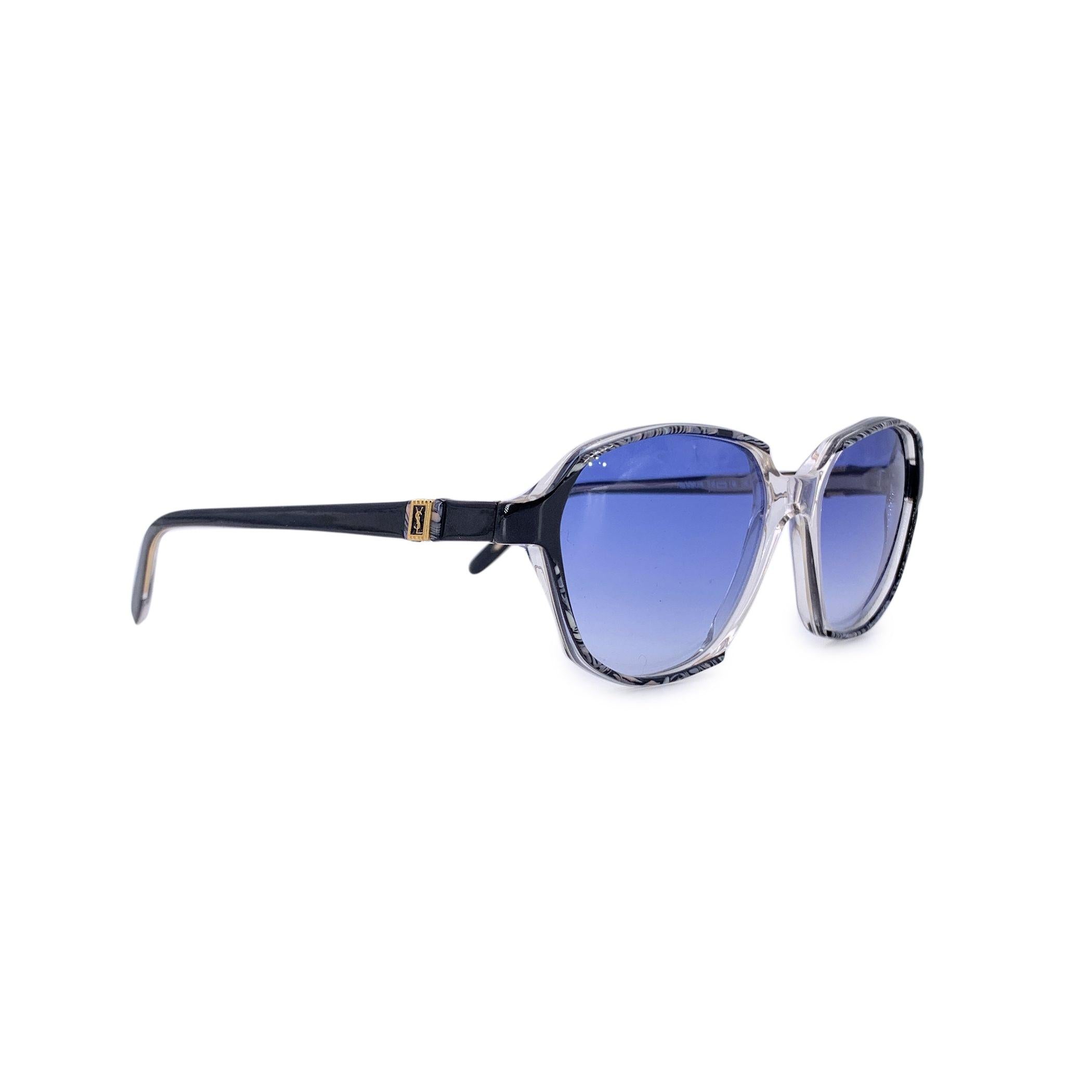 Fiercely feminine and unapologetically bold, these Yves Saint Laurent vintage blue sunglasses, model NESSUS, are a vivid expression of 1980s glamour. With their dramatic rectangle butterfly silhouette and clear and blue frame, they channel the