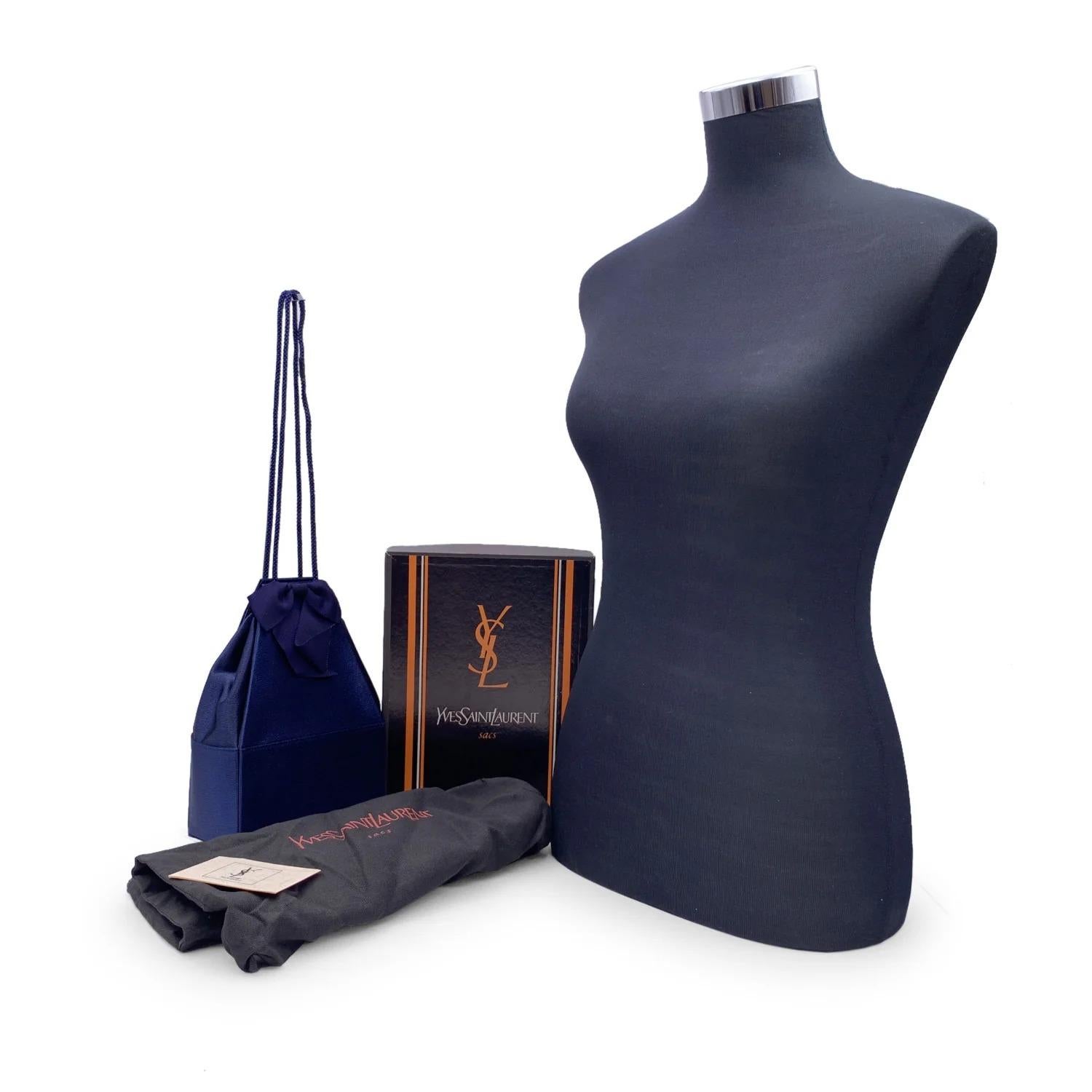 Gorgeous vintage rare small bucket shoulder or crossbody bag by Yves Saint Laurent. In dark electric blue satin, geometric pyramidal shape, with a beautiful blue ribbon on the front. Blue internal lining, with YVES SAINT LAURENT gold printed