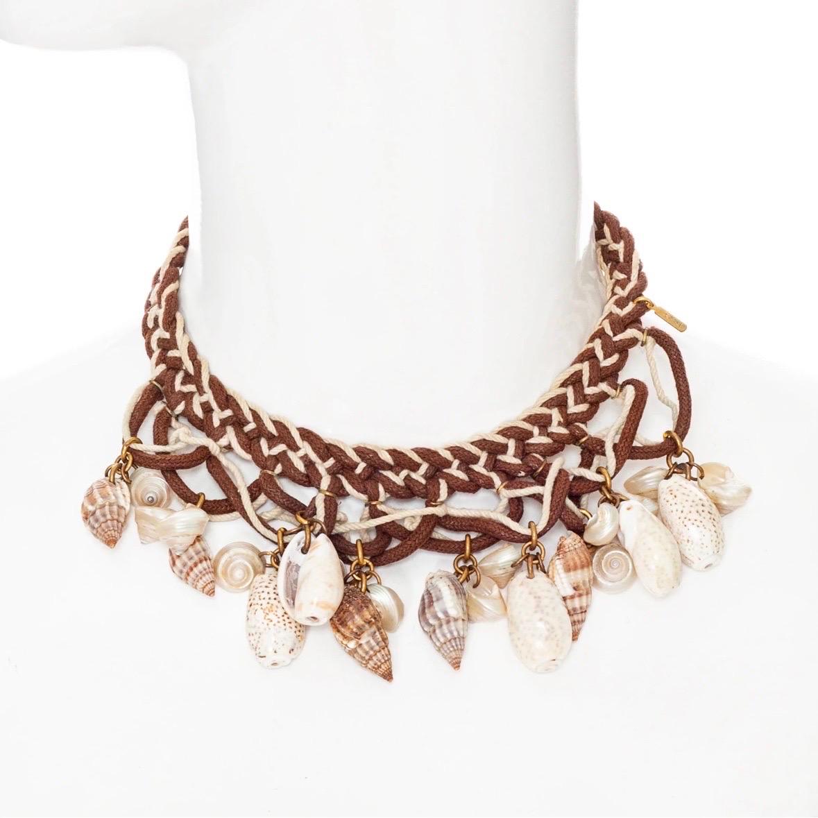 Yves Saint Laurent Vintage Brown and Cream Shell Necklace
Vintage; circa 1970s
Brown/Ivory/Cream
Nautical-inspired braided rope
Various shells adorn front
Gold-hardware and logo tag
Beaded loop closure at neck
Great vintage preowned condition;