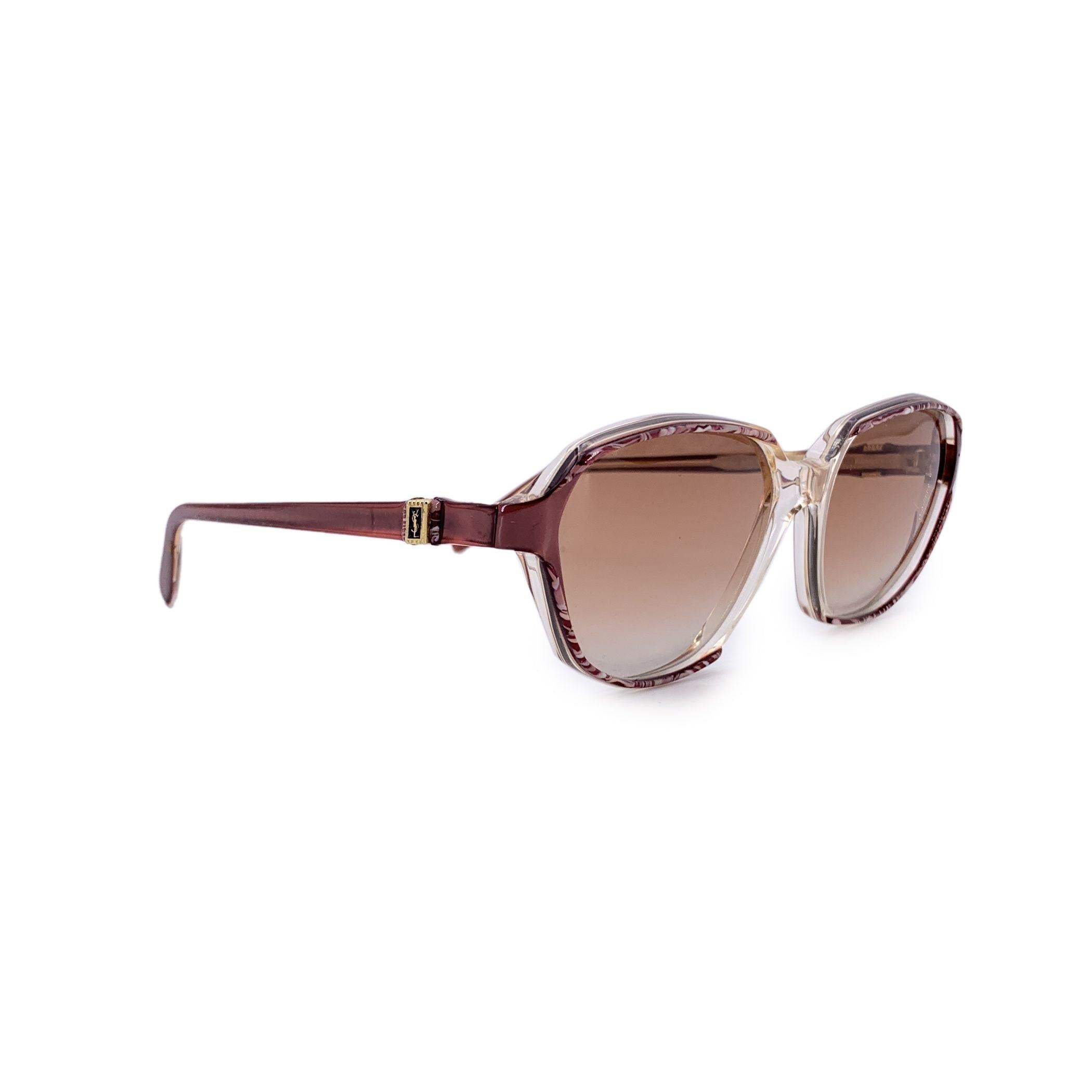 Fiercely feminine and unapologetically bold, these Yves Saint Laurent vintage brown sunglasses, model NESSUS, are a vivid expression of 1980s glamour. With their dramatic rectangle butterfly silhouette and clear and brown frame, they channel the