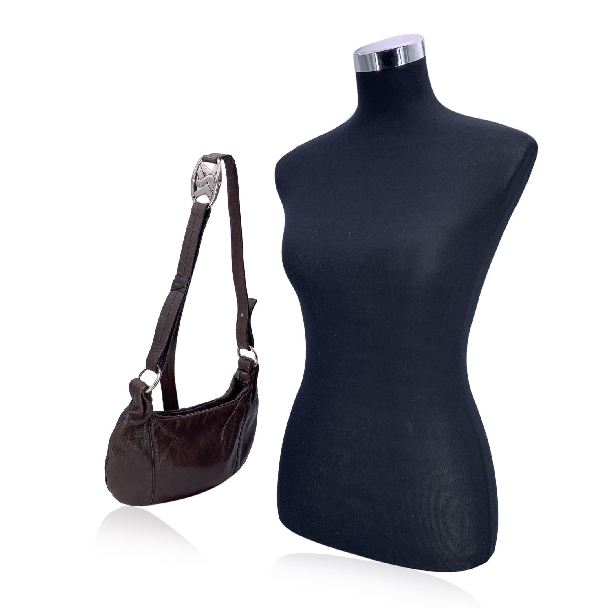 Embrace timeless elegance with this small vintage Yves Saint Laurent shoulder bag, a perfect blend of classic design and understated luxury. Crafted from luxurious brown leather, this bag features a sleek and sophisticated finish that adds a refined