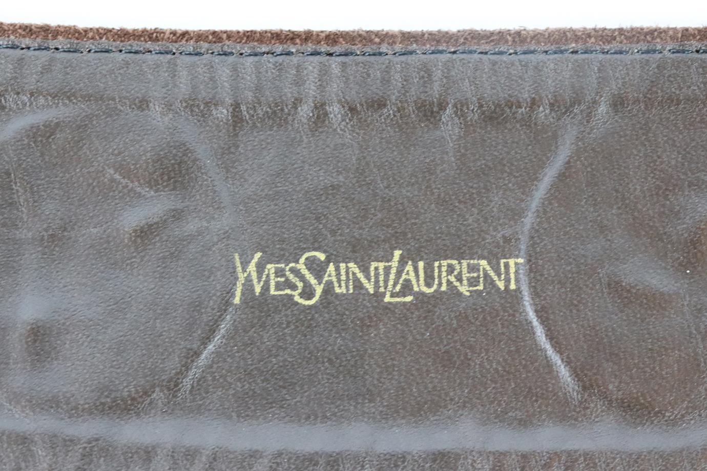 Yves Saint Laurent Vintage embellished suede waist belt. Made from brown suede with gold-tone mottled hearts. Brown. Buckle fastening at front. Min Length: 27.5 in. Max Length: 30 in. Width: 2.5 in