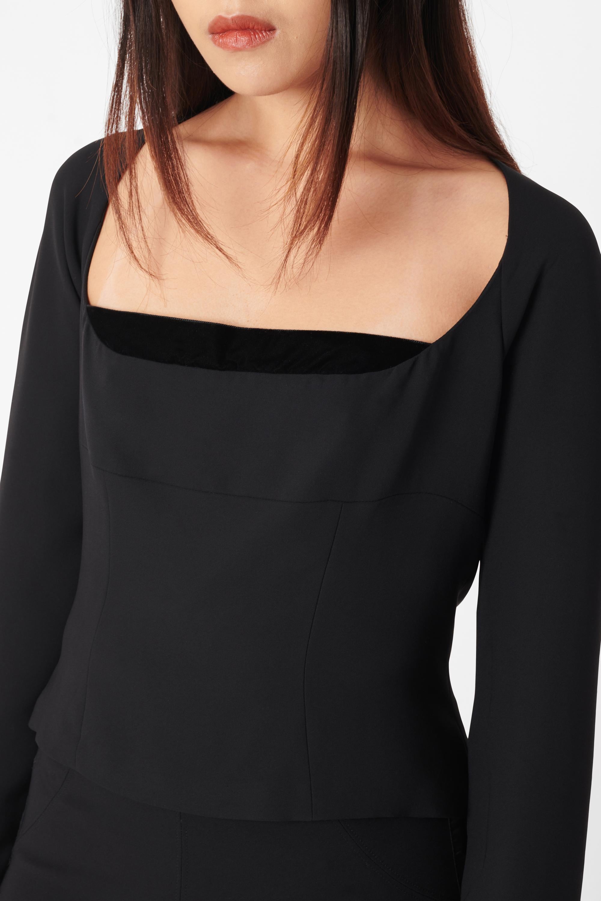 Vintage Yves Saint Laurent by Tom Ford Rive Gauche Fall Winter 2002 black long sleeve blouse. Features a square neckline shaped with velvet, seaming along the body, long sleeves with lightly billowed cuffs, open back with velvet ribbon tie back. In