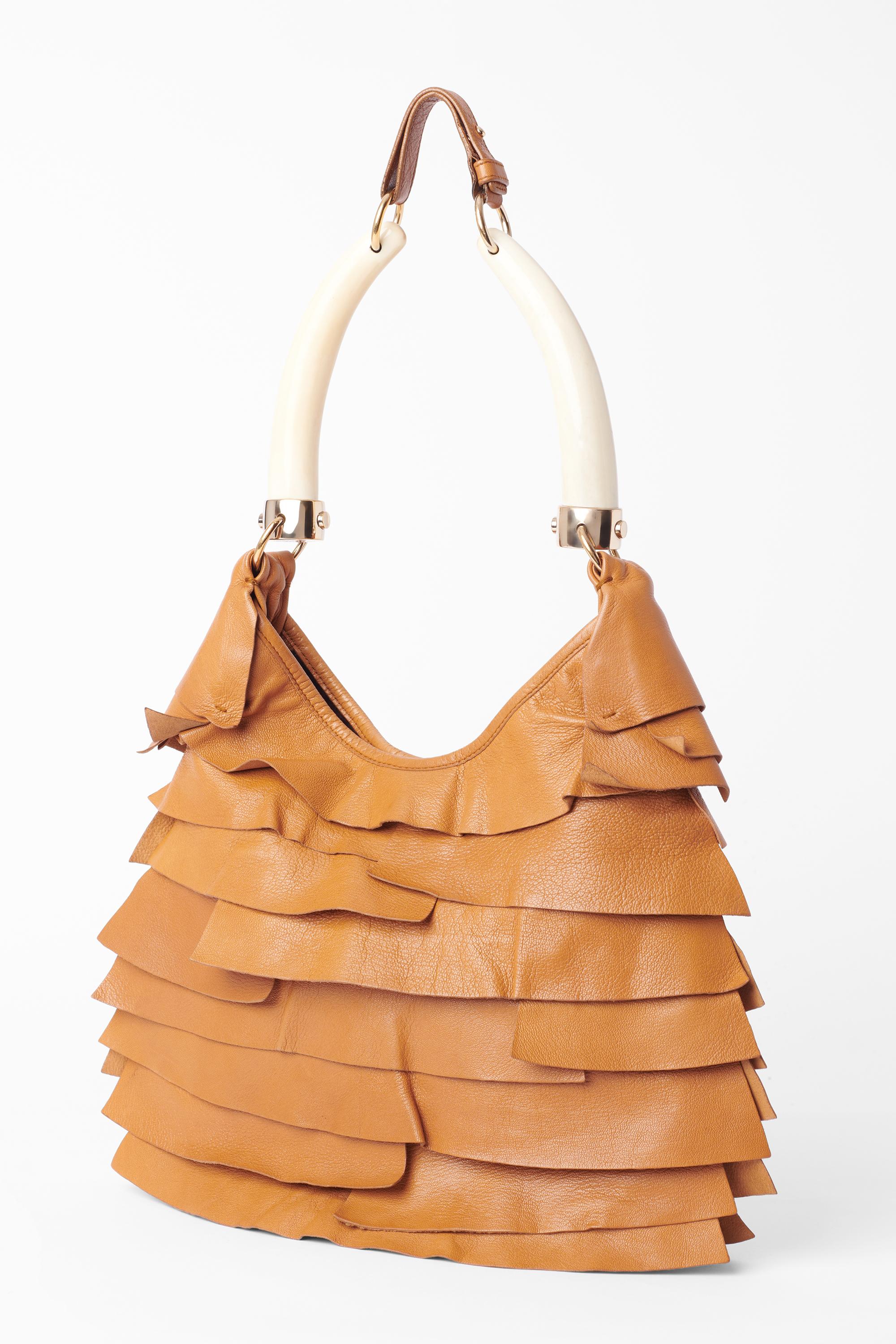 YSL by Tom Ford camel St Tropez ruffled bag from the Fall/Winter 2004 Rive Gauche. Features double Horn handle , adjustable strap, ruffled leather body magnetic button closure. YSL branded in shiny gold tone, inner zip pocket. In excellent vintage