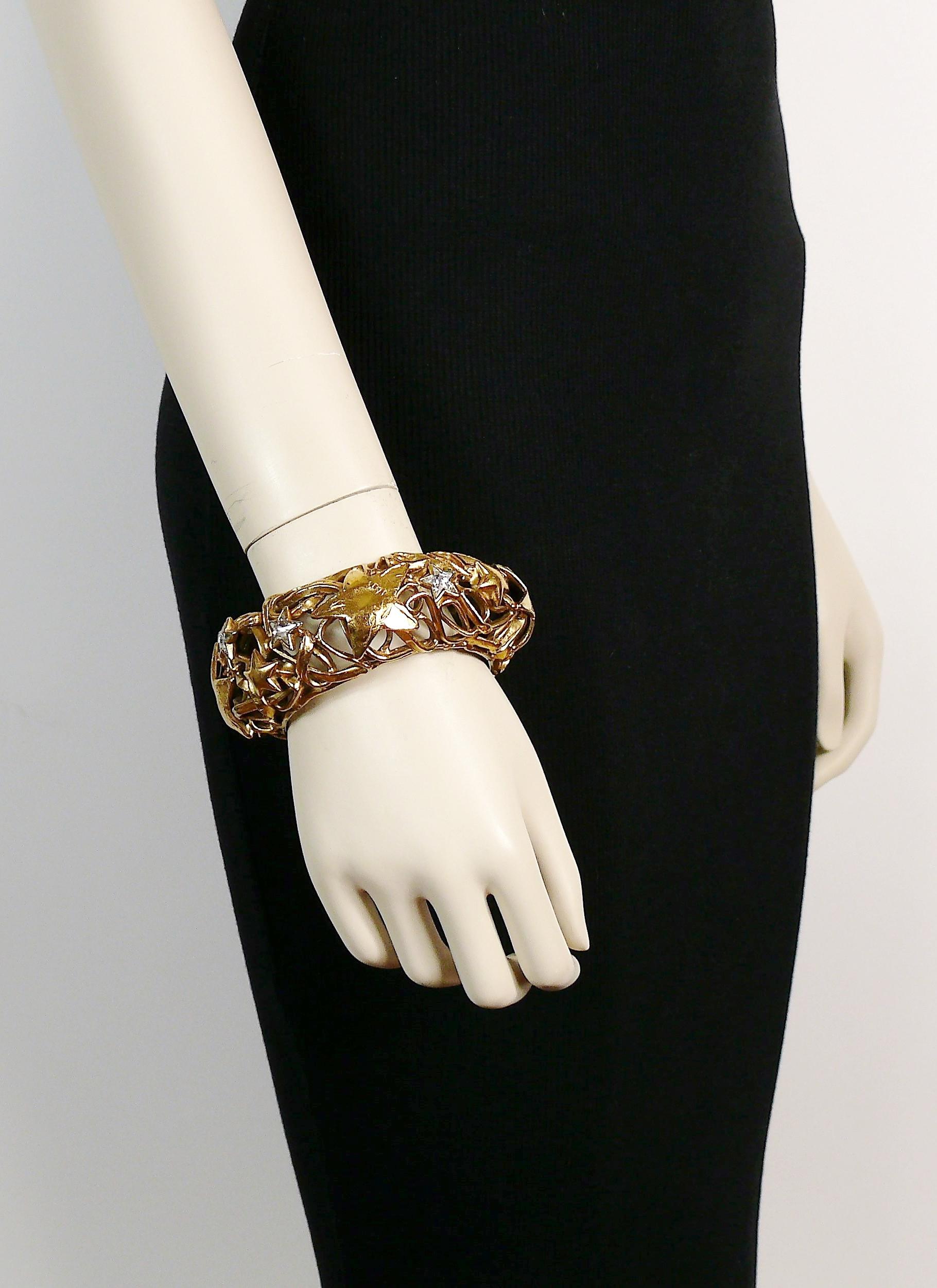 YVES SAINT LAURENT vintage rare gold toned cuff bracelet featuring a coiled wire pattern, stars and star-shaped clear crystals.

Slips on.

Embossed YVES SAINT LAURENT RIVE GAUCHE Made in France.

Indicative measurements : inner circumference