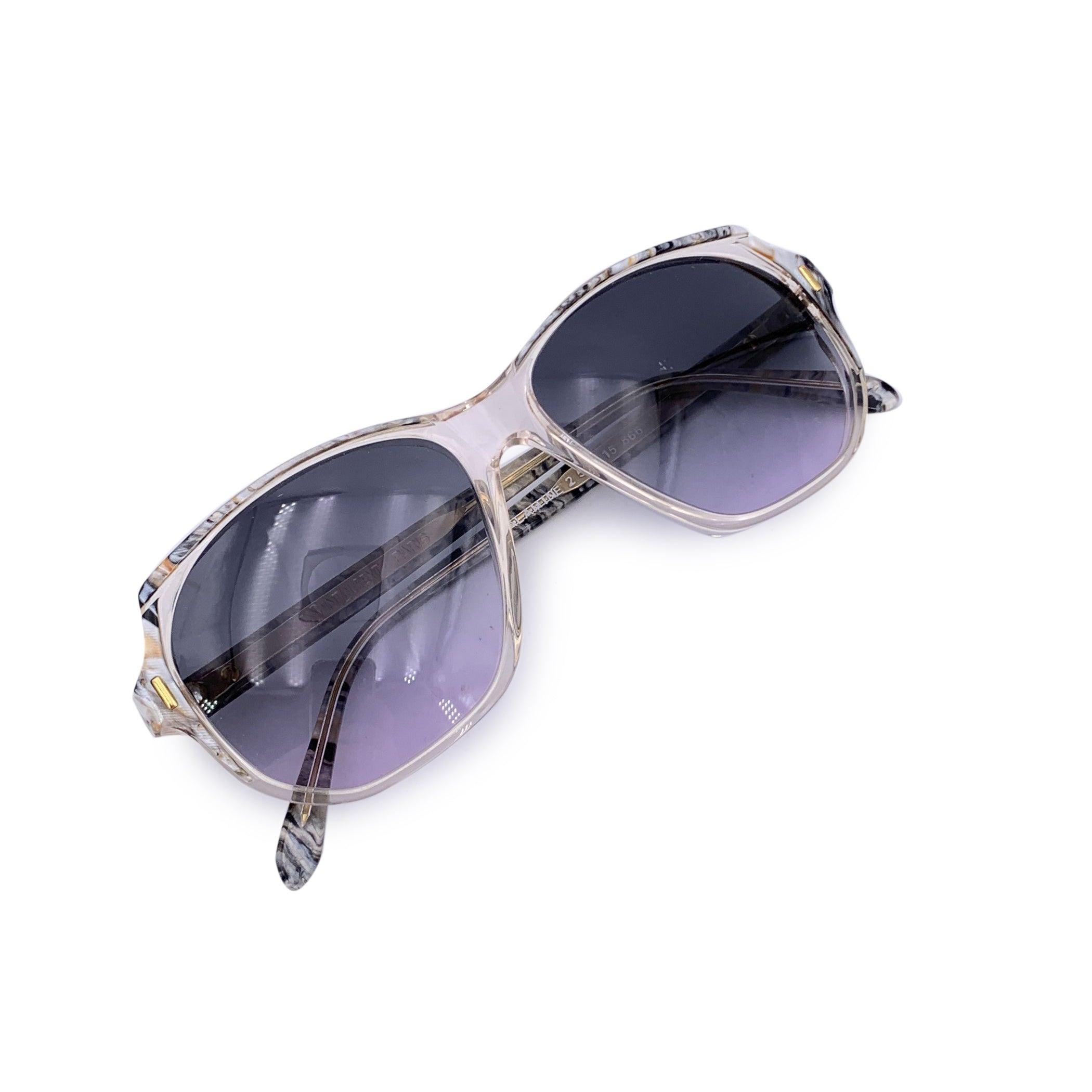 A refined echo from the haute couture runways of the 1980s, these Yves Saint Laurent Vintage SALAMINE Sunglasses are a captivating expression of quiet luxury and sculptural design. Crafted in France and impeccably preserved in A - EXCELLENT