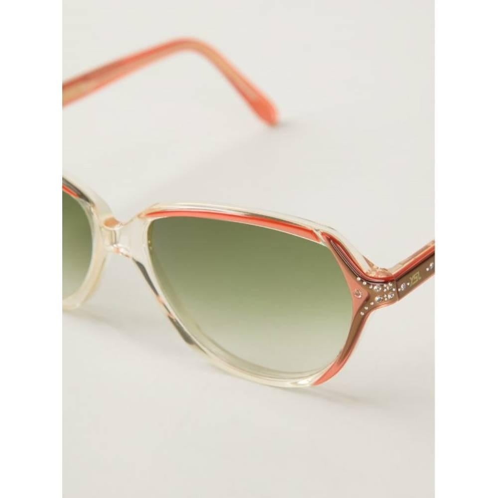 Yves Saint Laurent orange 70s sunglasses. Green shaded lenses. Strass decoration.

Width: 13,5 cm
Height: 4,5 cm

Product code: A8389

Notes: Please note this item cannot be shipped to the US.

Composition: Acetate

Made in: France

Condition: Very