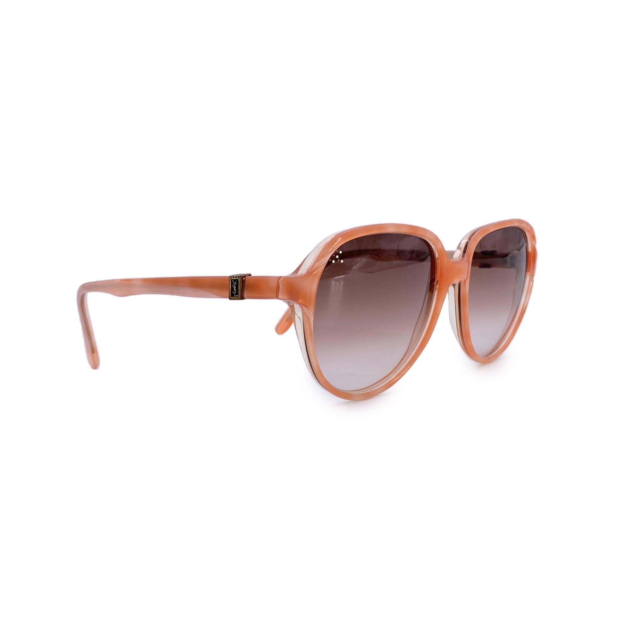 Infused with bold character and effortless French flair, these vintage Yves Saint Laurent sunglasses, model Sarpedon, are a striking relic of fashion-forward design. The standout delicate pink acetate frame captures the daring spirit of YSL, making