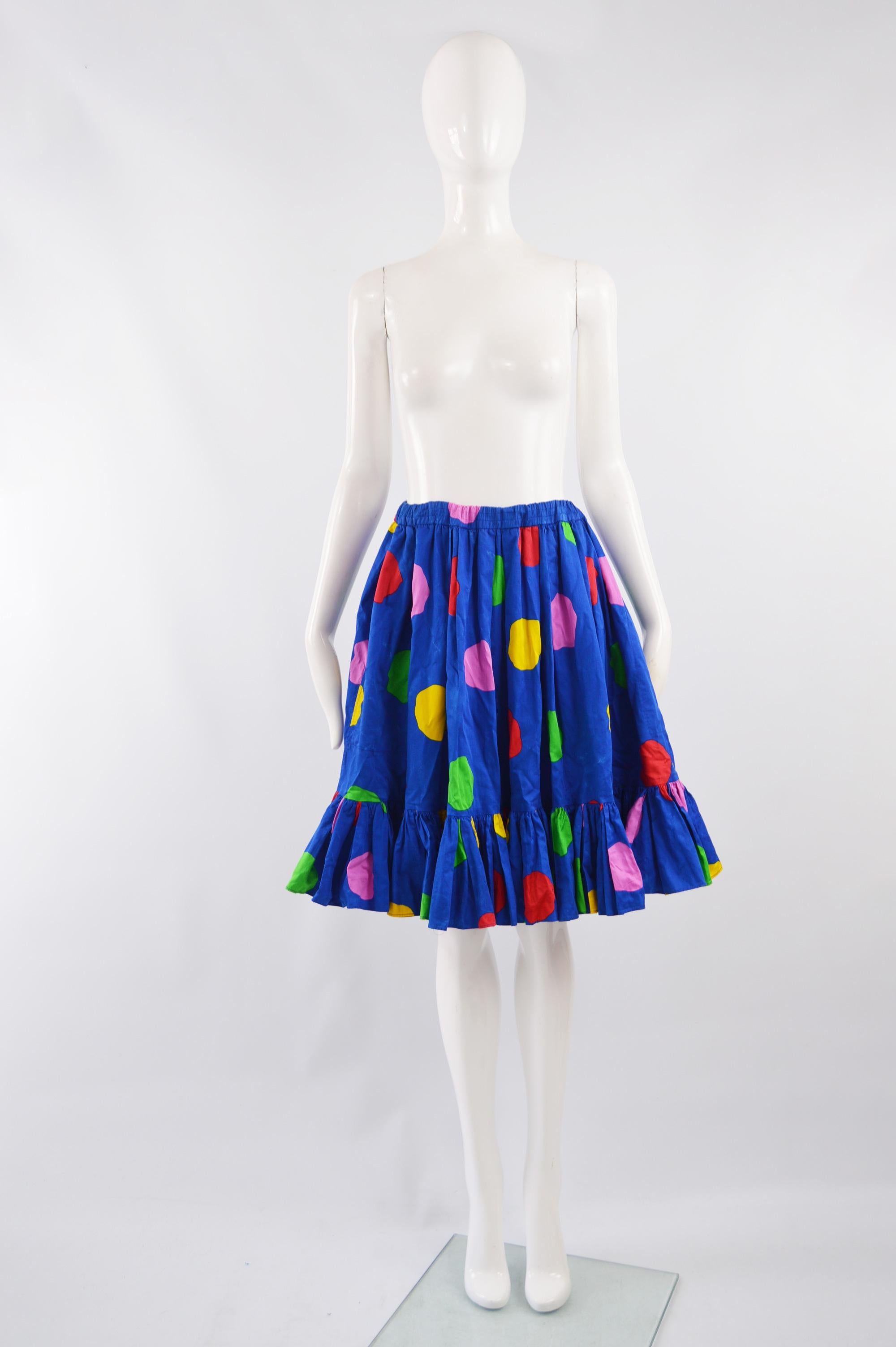 An amazing vintage YSL Rive Gauche skirt from the 80s in a blue cotton with multicolored oversized polka dots throughout. The skirt is full with an elasticated waist and a ruffled flounce to the hem. 

Size: Marked FR 40 which is roughly a UK 12/ US