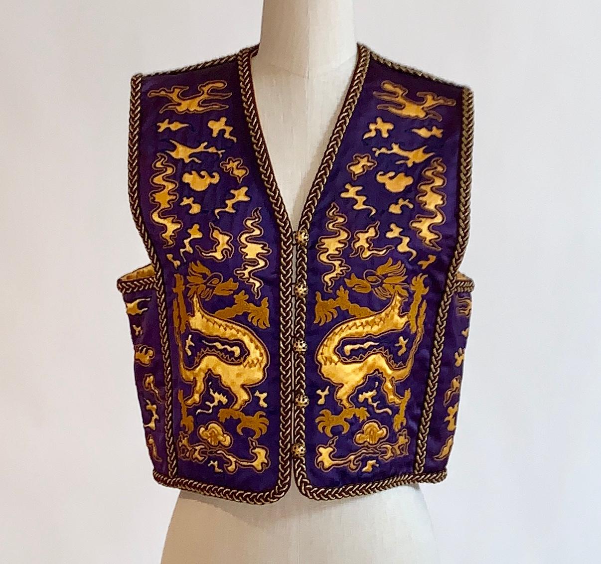 Yves Saint Laurent Rive Gauche 1960s or 1970s vintage satiny purple cropped waistcoat vest which has been embroidered and cut away to reveal a gold dragon print. Gold braided trim and beautiful black and gold buttons with loop closures. Documented,