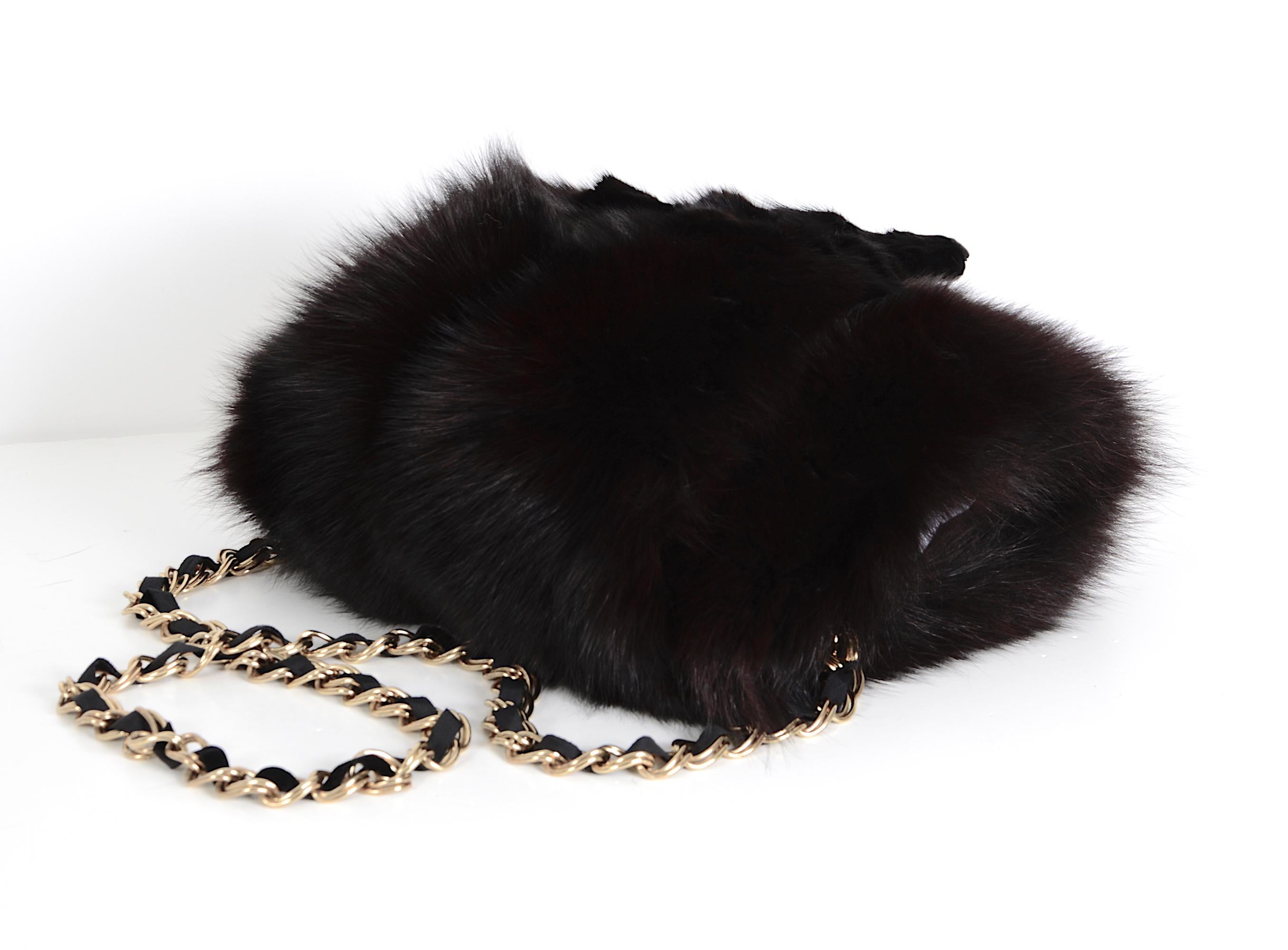 Yves Saint Laurent vintage black fox fur hand warmer muff bag with removable attached heavy gold-tone chain. I have never come across this spectacular piece before and I'm not sure from when it dates, could be the 70s, 80s, or 90s. Inside this