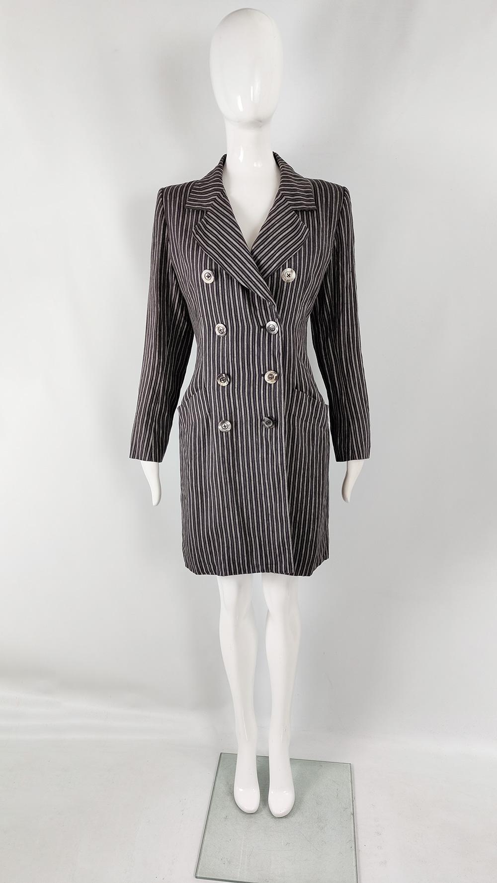 A stunning vintage womens jacket from the late 80s / early 90s by Yves Saint Laurent. Made in France from a black linen with a grey vertical pinstripe throughout. The cut is sublime, with wide shoulder pads giving a structured, high fashion look