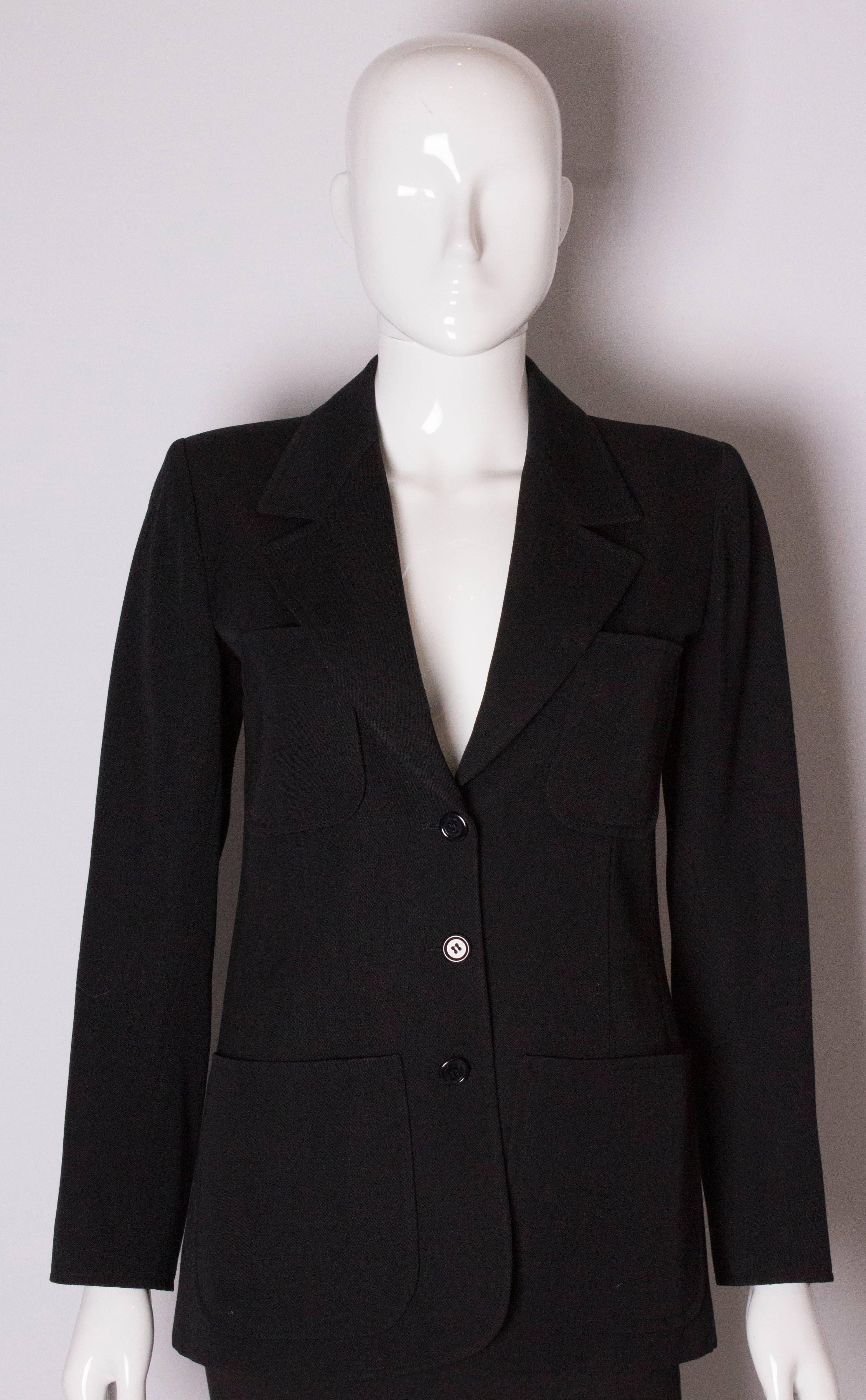 A chic wool jacket by Yves Saint Laurent Rive Gauche. In a dark blue wool, the jacket has 2 breast pockets and 2 pockets at hip leval. It has a 3 button opening at the front and 3 buttons on each cuff.