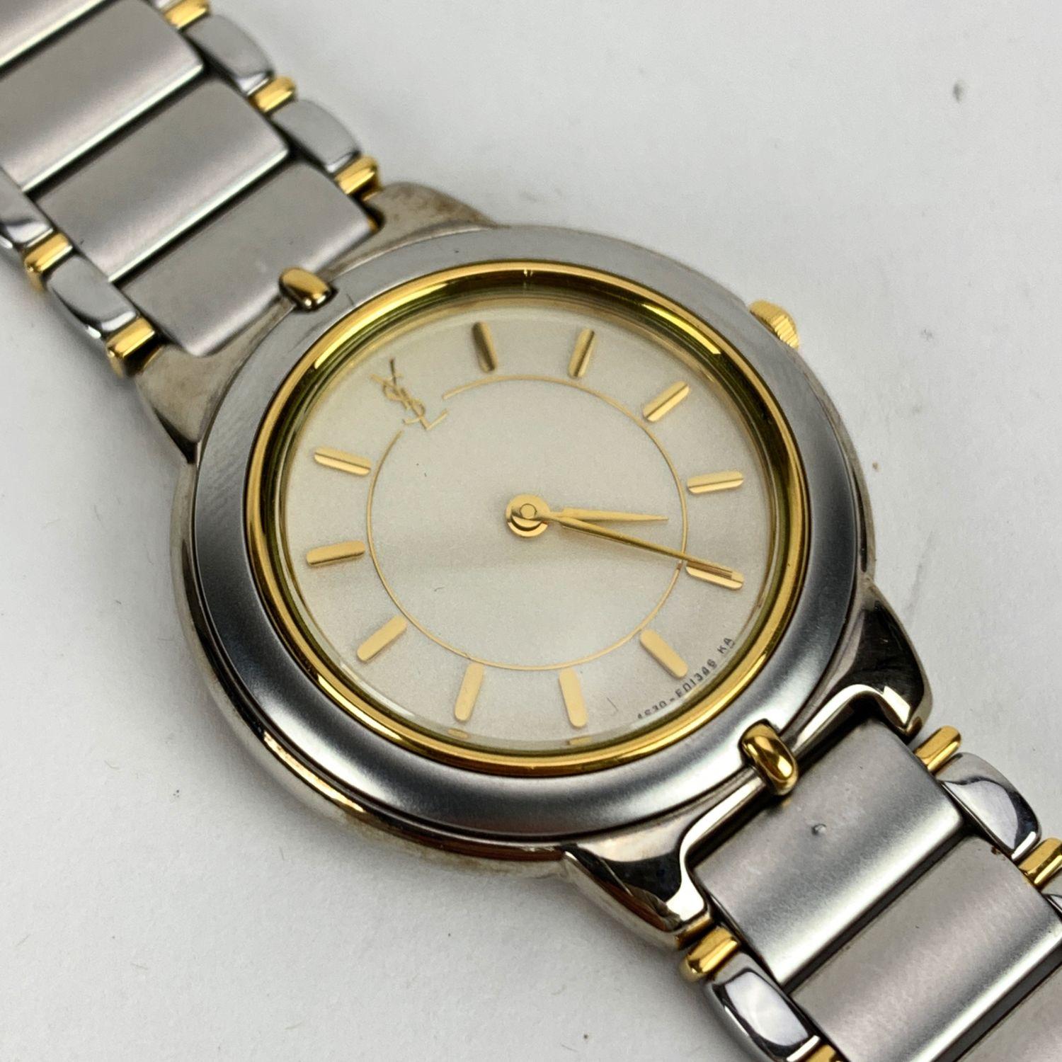 Vintage Yves Saint Laurent wrist watch. Model 4620-E62267 TA . Gold and silver metal. Base metal round case (30 mm). White dial. Total length: 7.5 inches - 19.05 cm

Condition

A - EXCELLENT

The watch is in working condition. Yves Saint Laurent box
